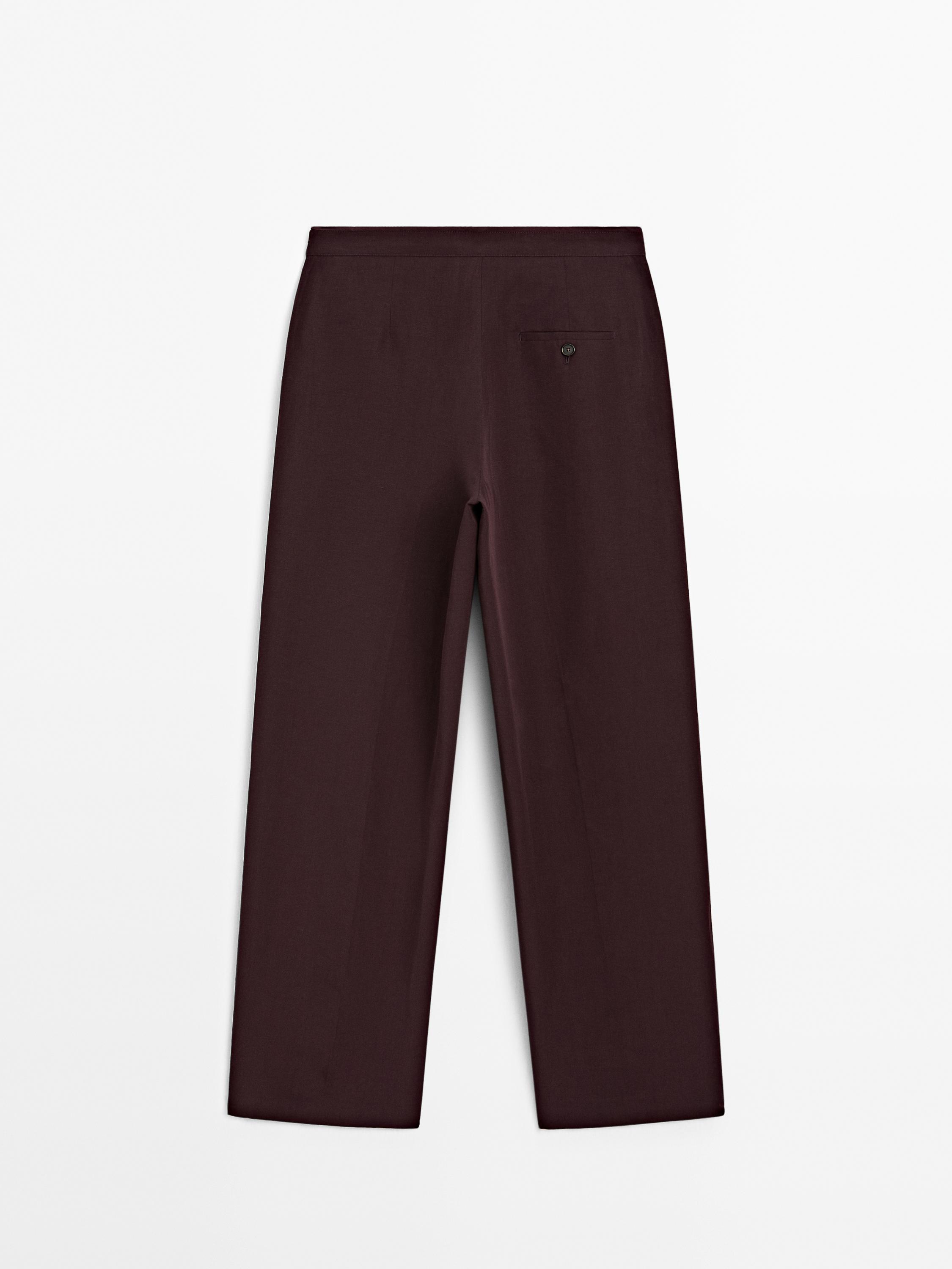 Flowing trousers with darts and thin waistband