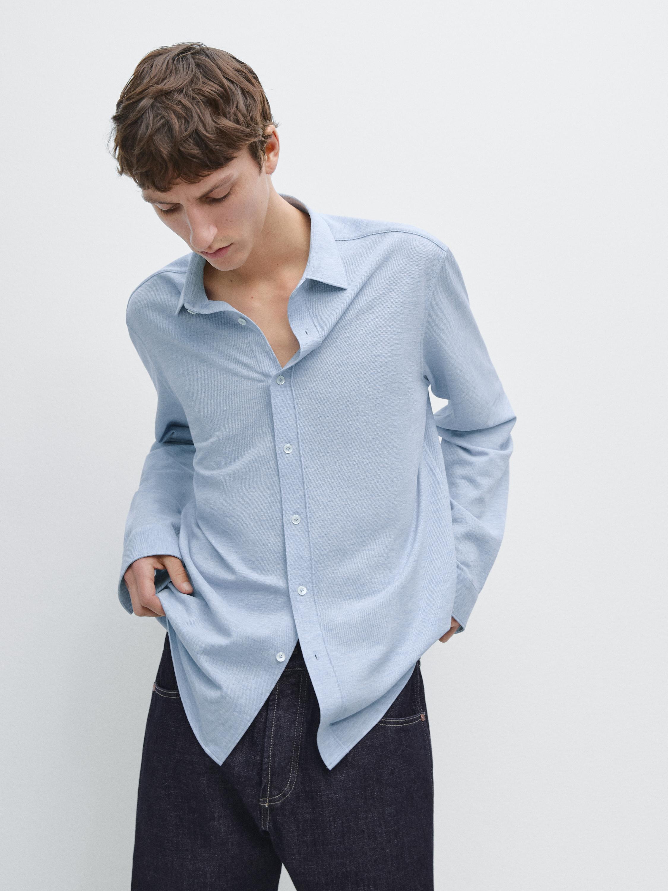 Light blue long-sleeved button-down shirt and dark pants set.