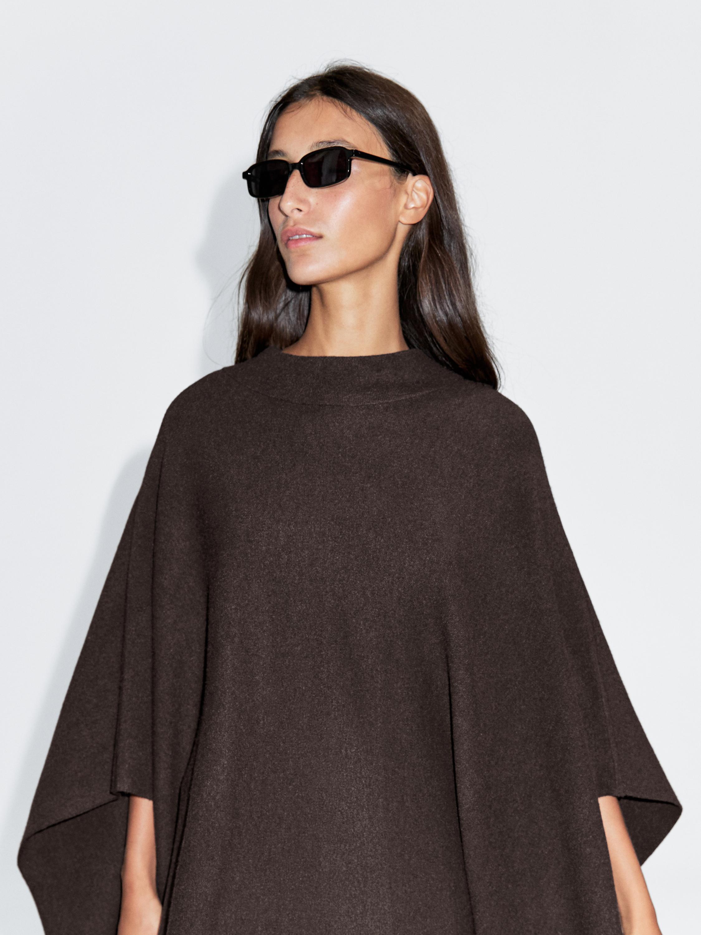 Medium shot of a brown cape with a high collar.