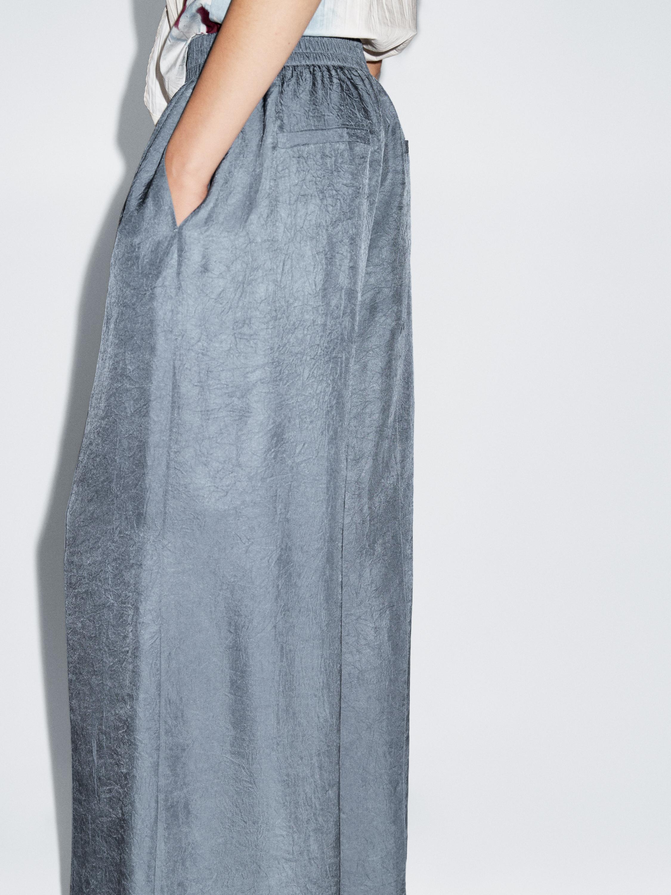 Creased-effect loose-fitting trousers