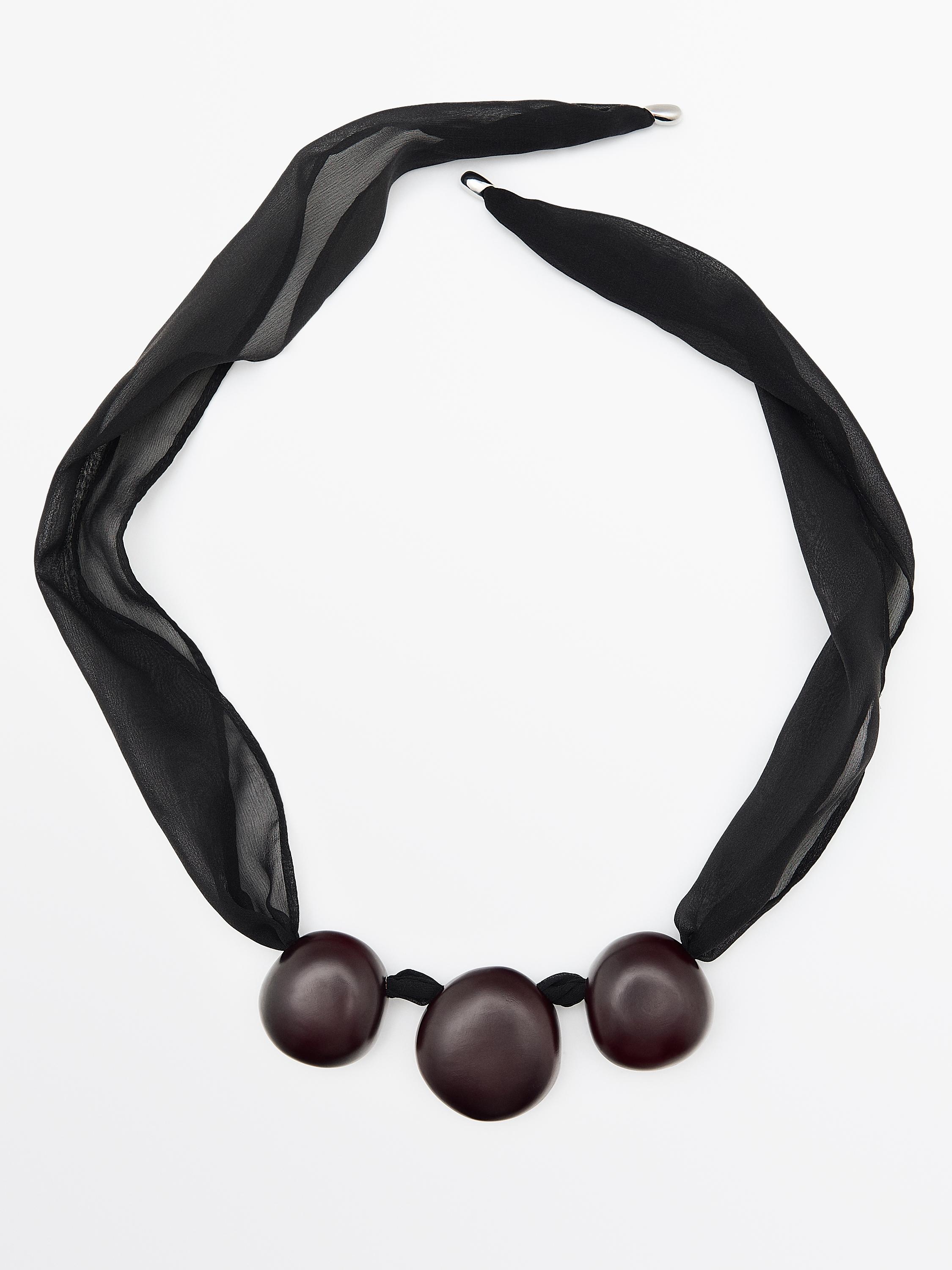 Penjoll tèxtil granadures fusta