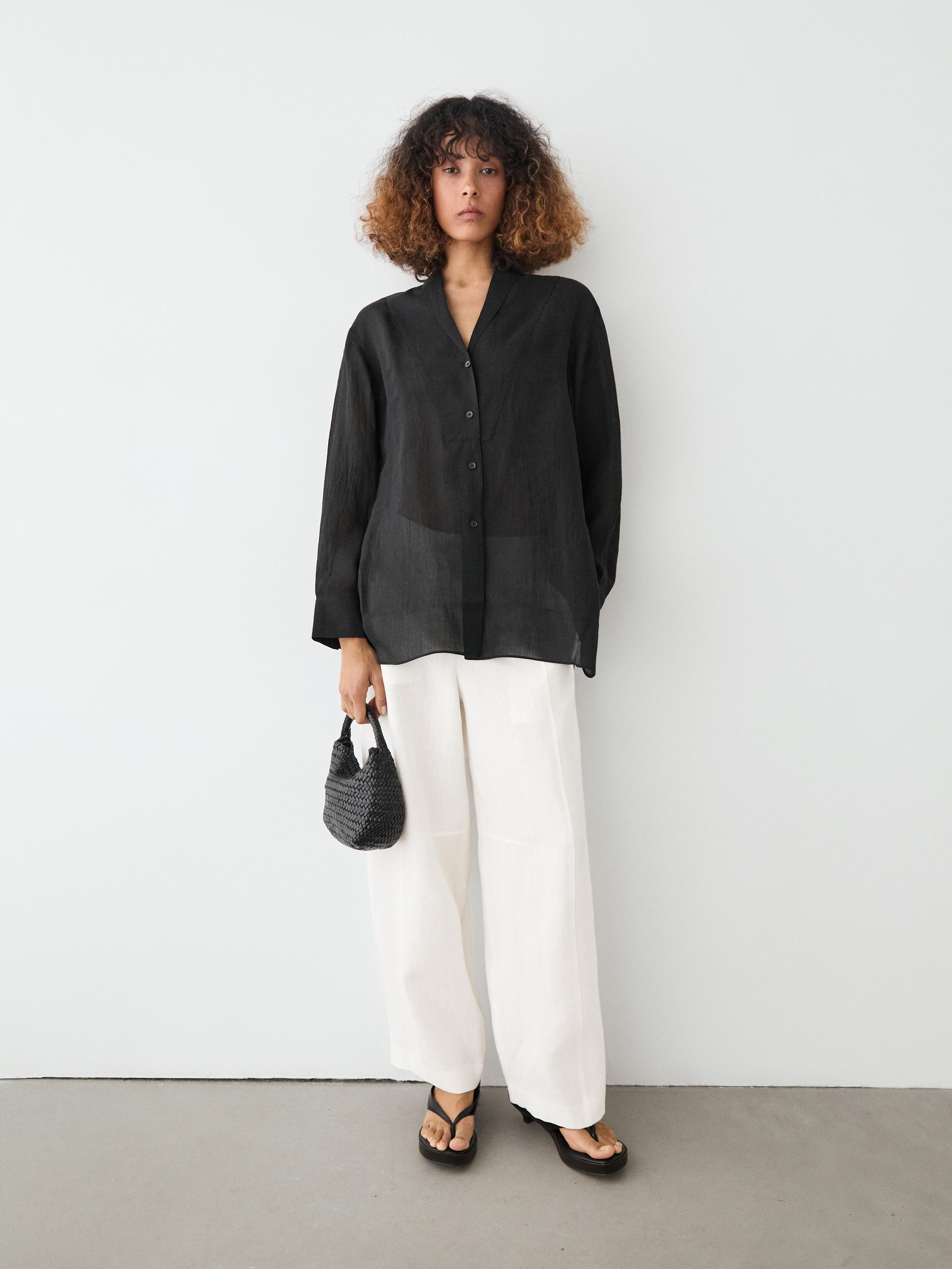 Flowing semi-sheer shirt with chest detail — BLACK