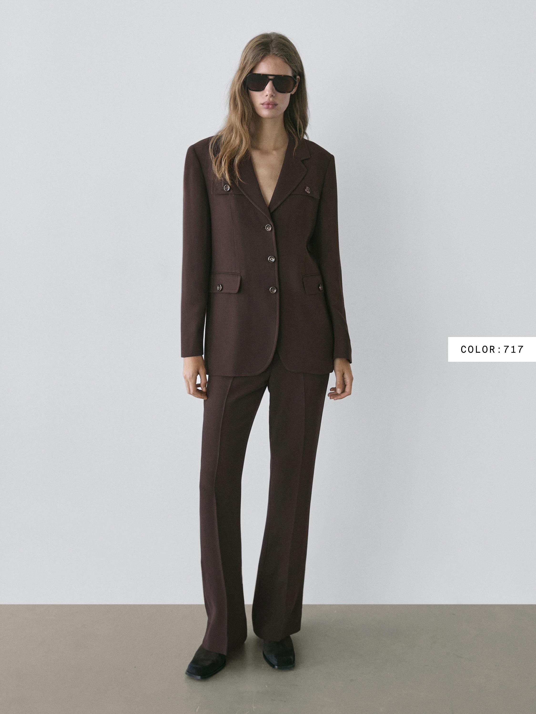 Dark brown suit set with a button-up jacket and flap pockets, straight-leg pants, and black shoes.