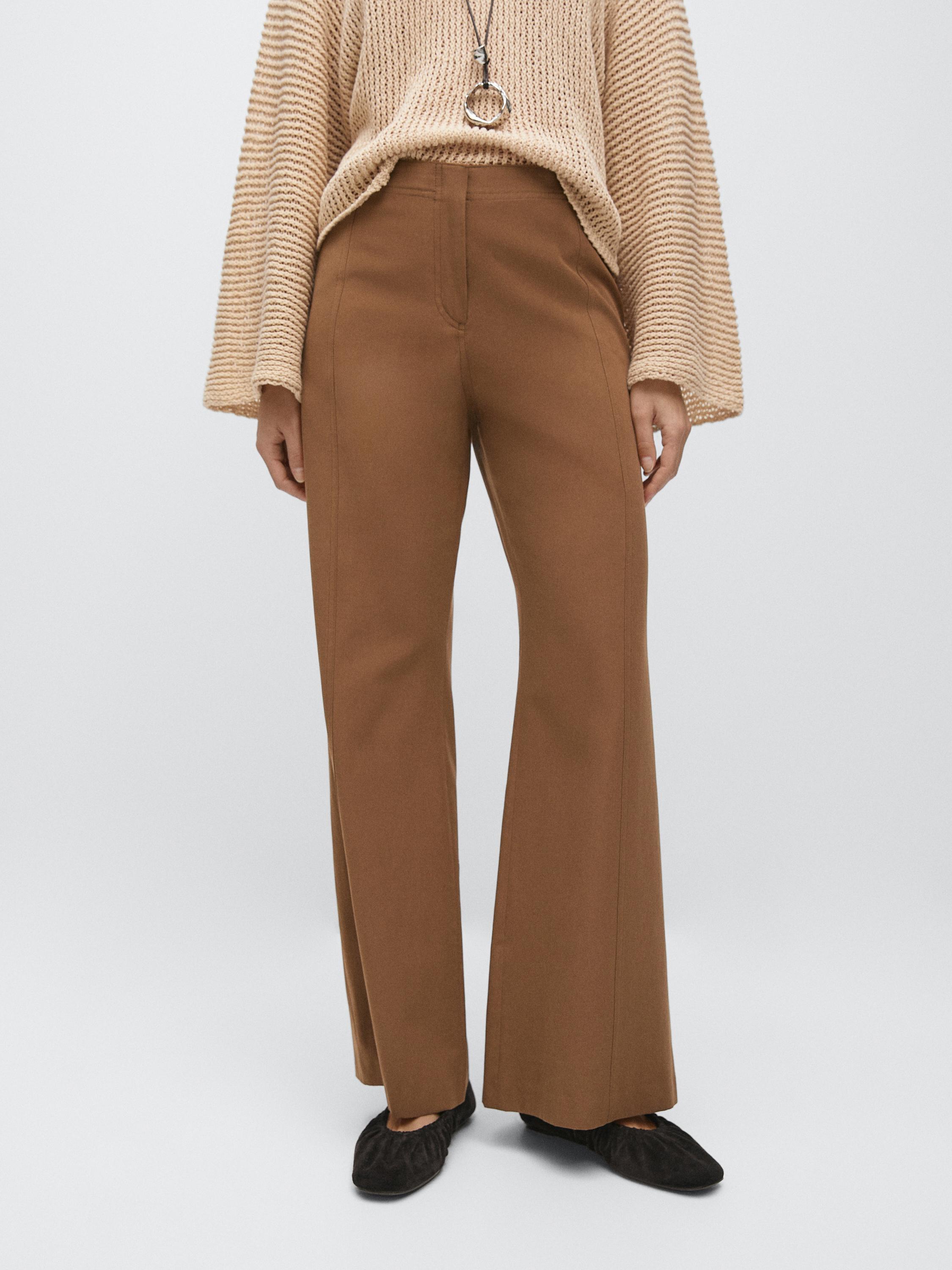 Tobacco flare pants set with side pockets and a beige knit sweater with wide sleeves.
