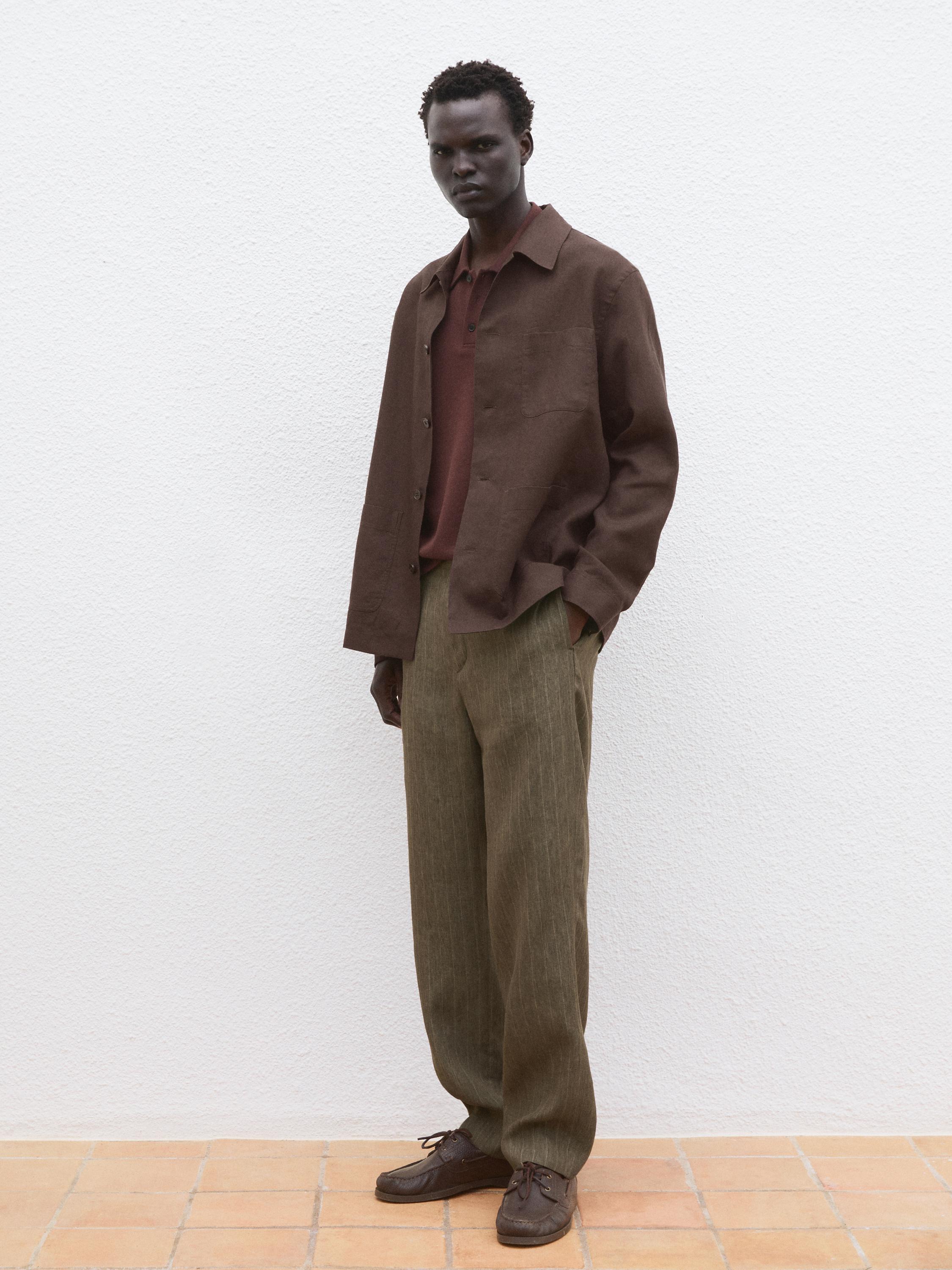 Brown shirt, burgundy polo shirt, and green wide-leg pants with brown shoes.