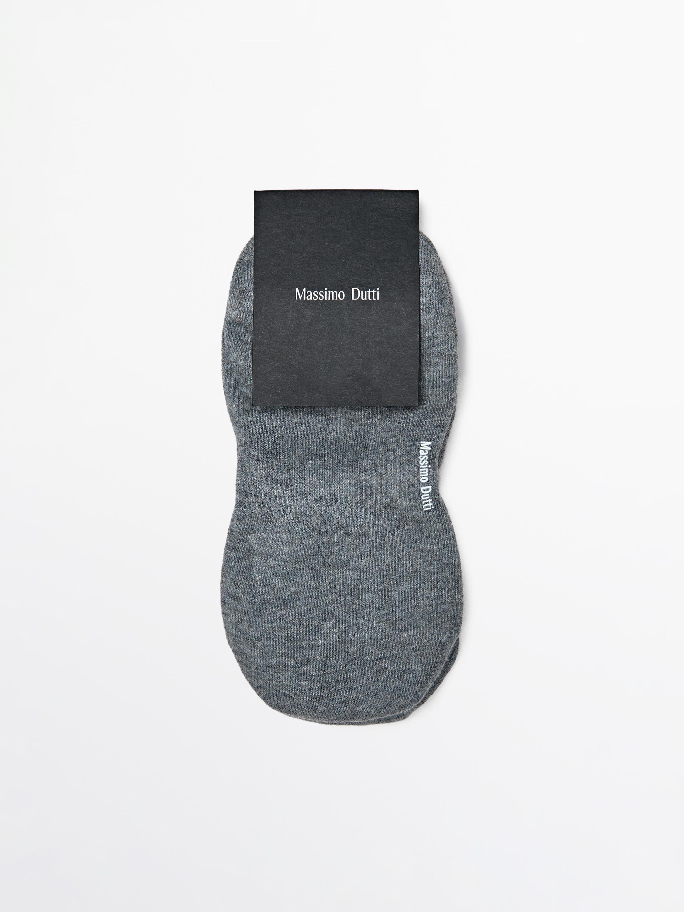 Front view of gray invisible socks with "Massimo Dutti" text on the packaging and side of the sock.