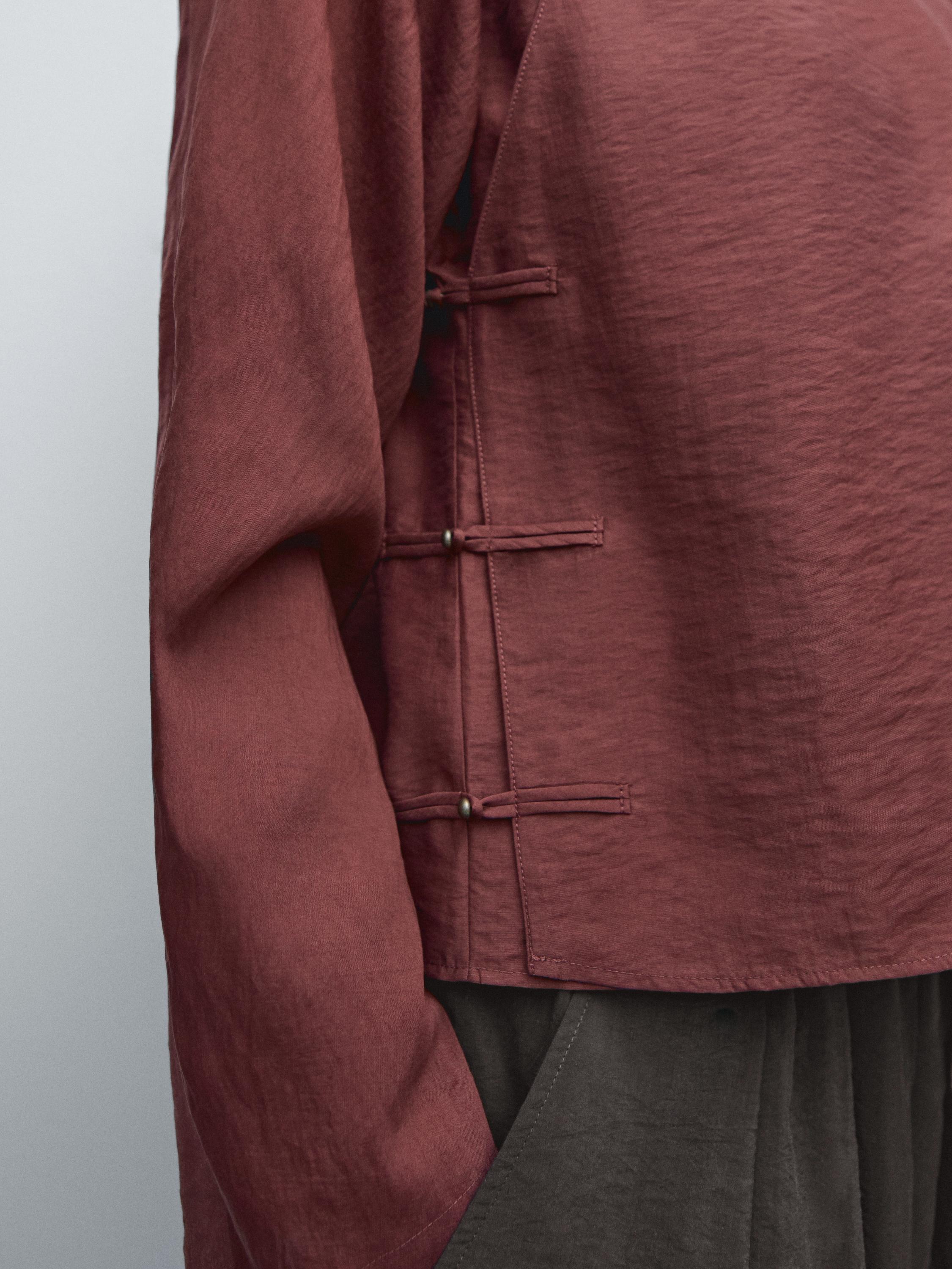 Flowing blouse with fastening detail