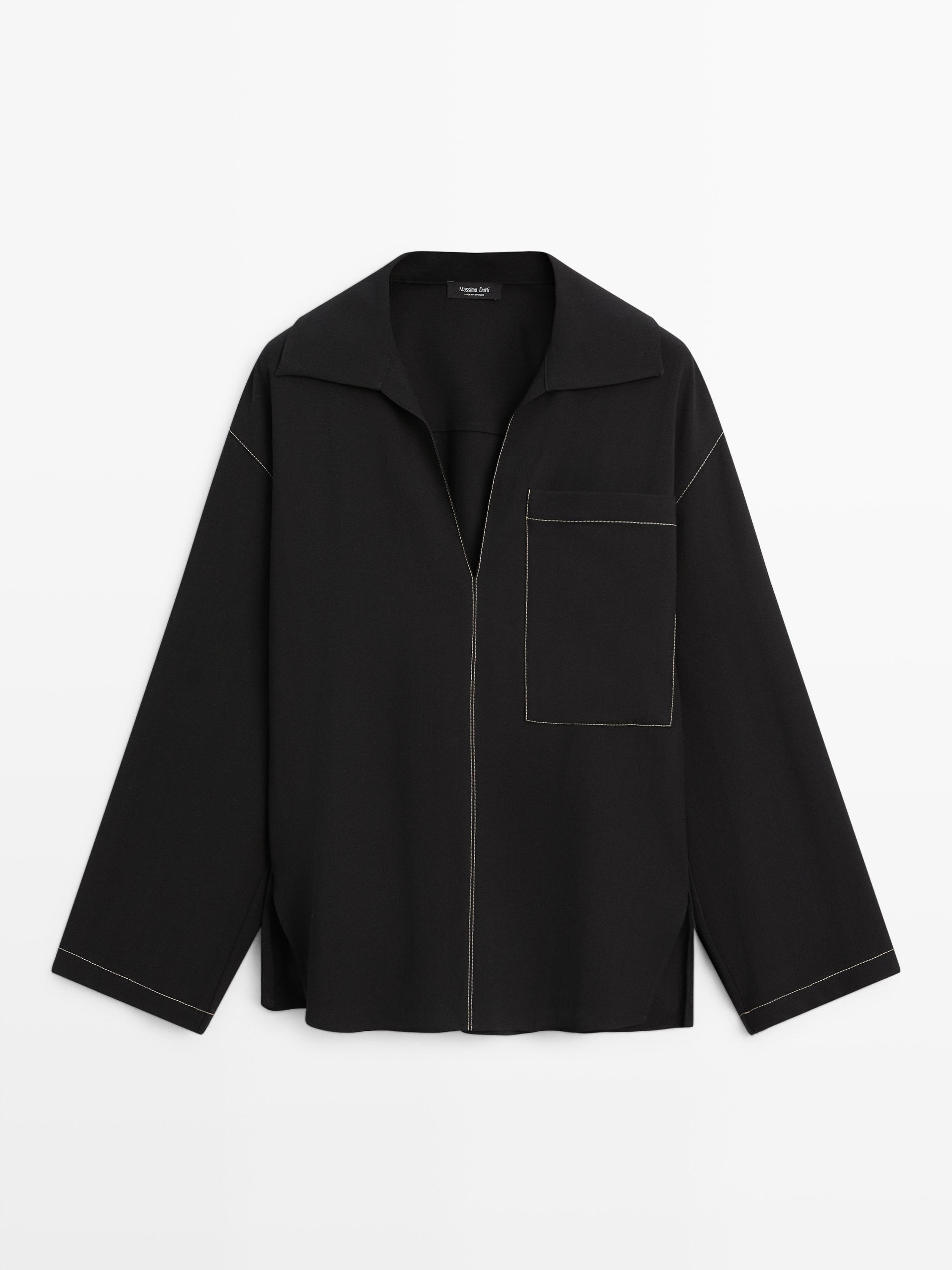 Front view of a black overshirt with a front pocket and visible contrast stitching.