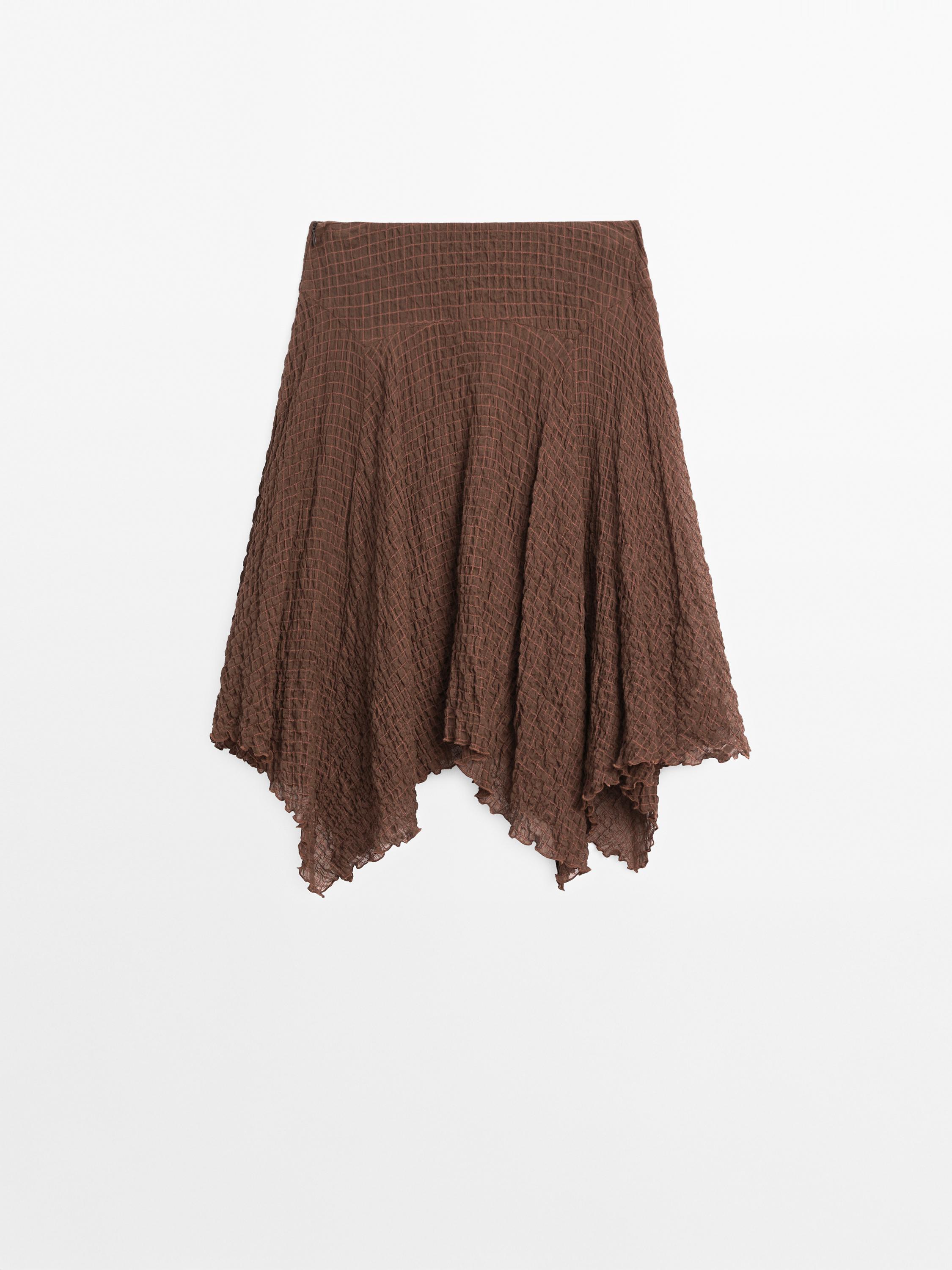 Flowing check skirt with asymmetric hem