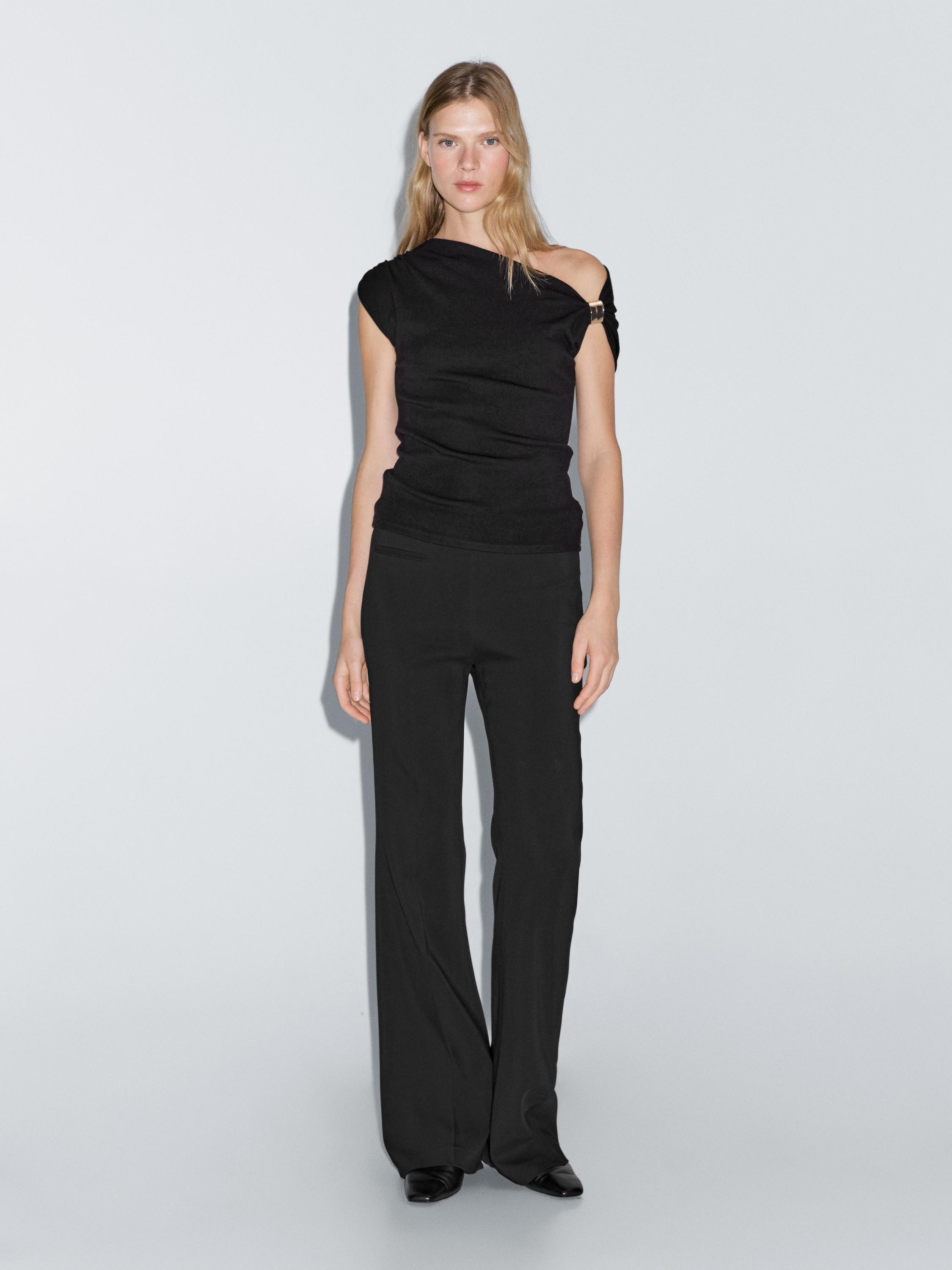 Sleeveless draped top with shoulder appliqué