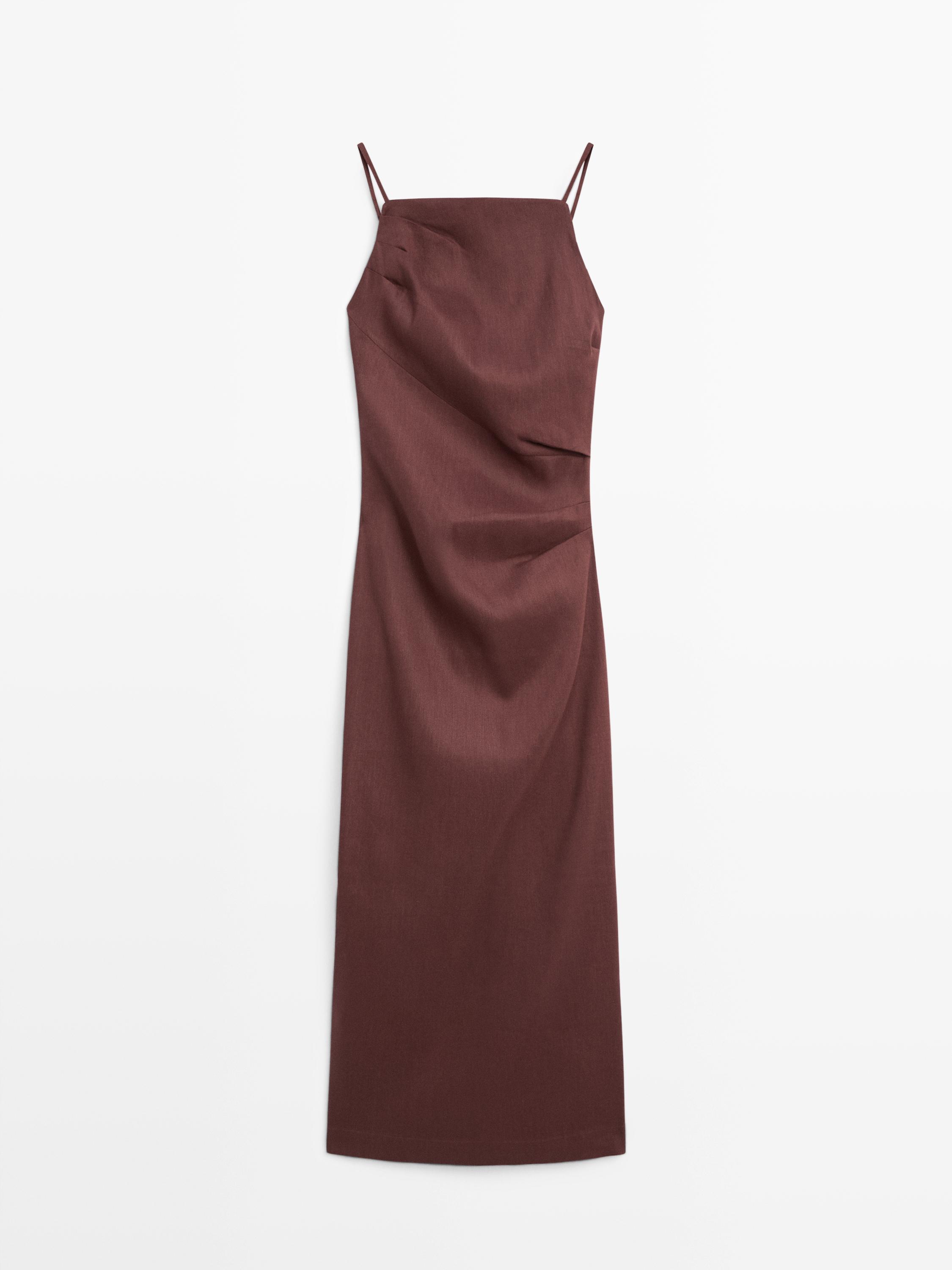 Front view of a chocolate midi dress with thin straps and side draping.