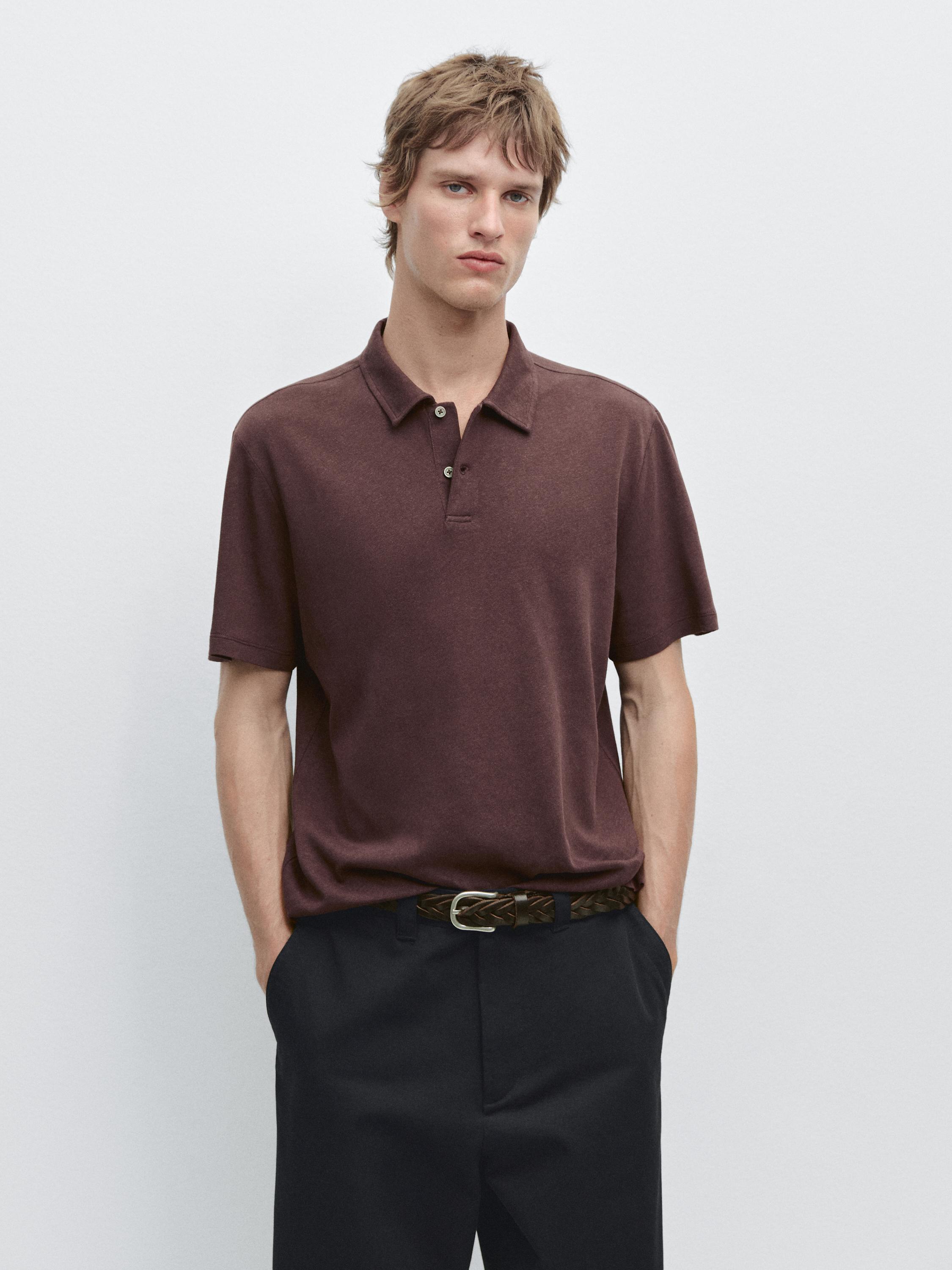 Burgundy short-sleeved polo set with classic collar and black pants with braided belt.