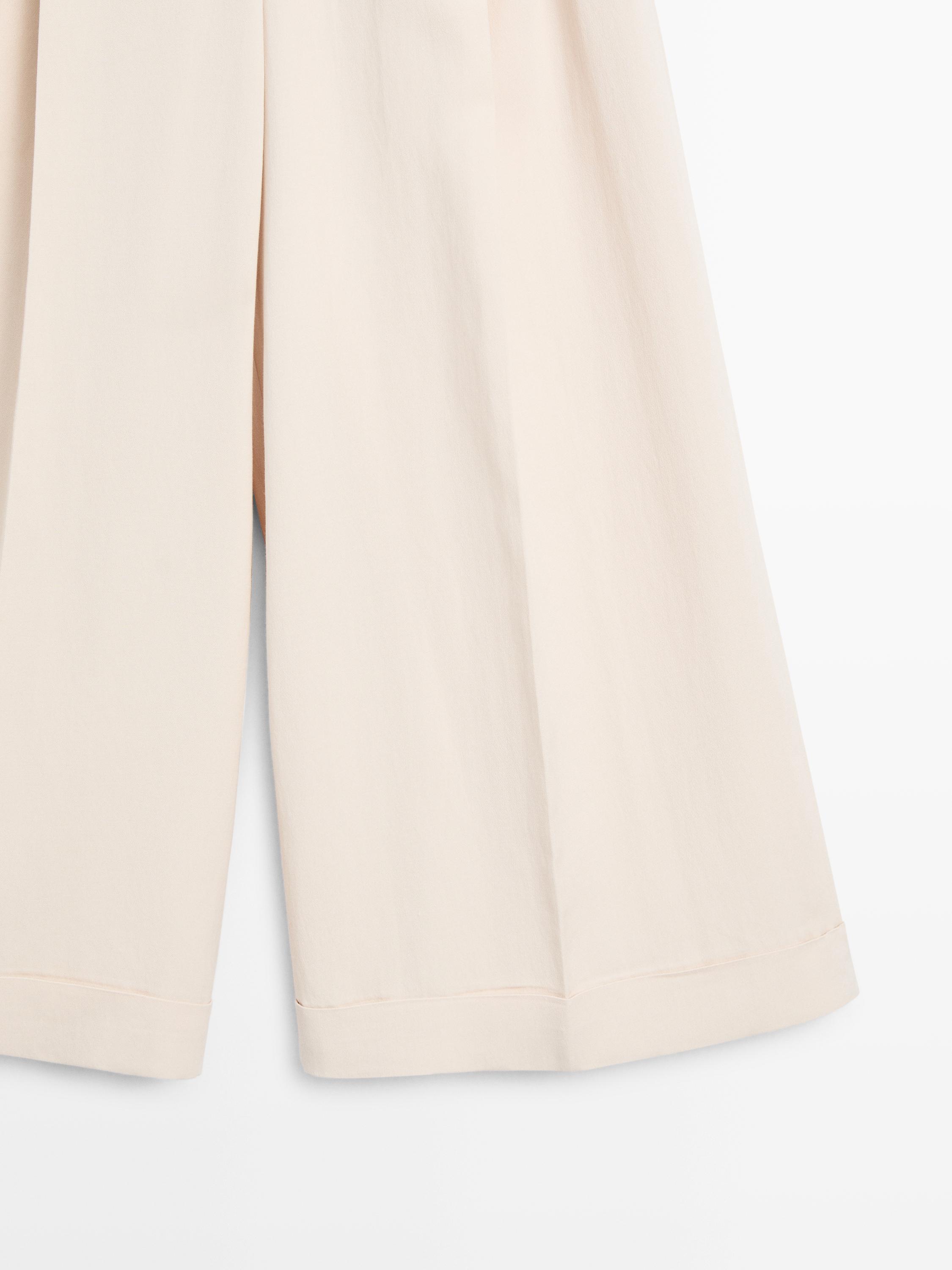 Flowing trousers with turn-up hems — CREAM