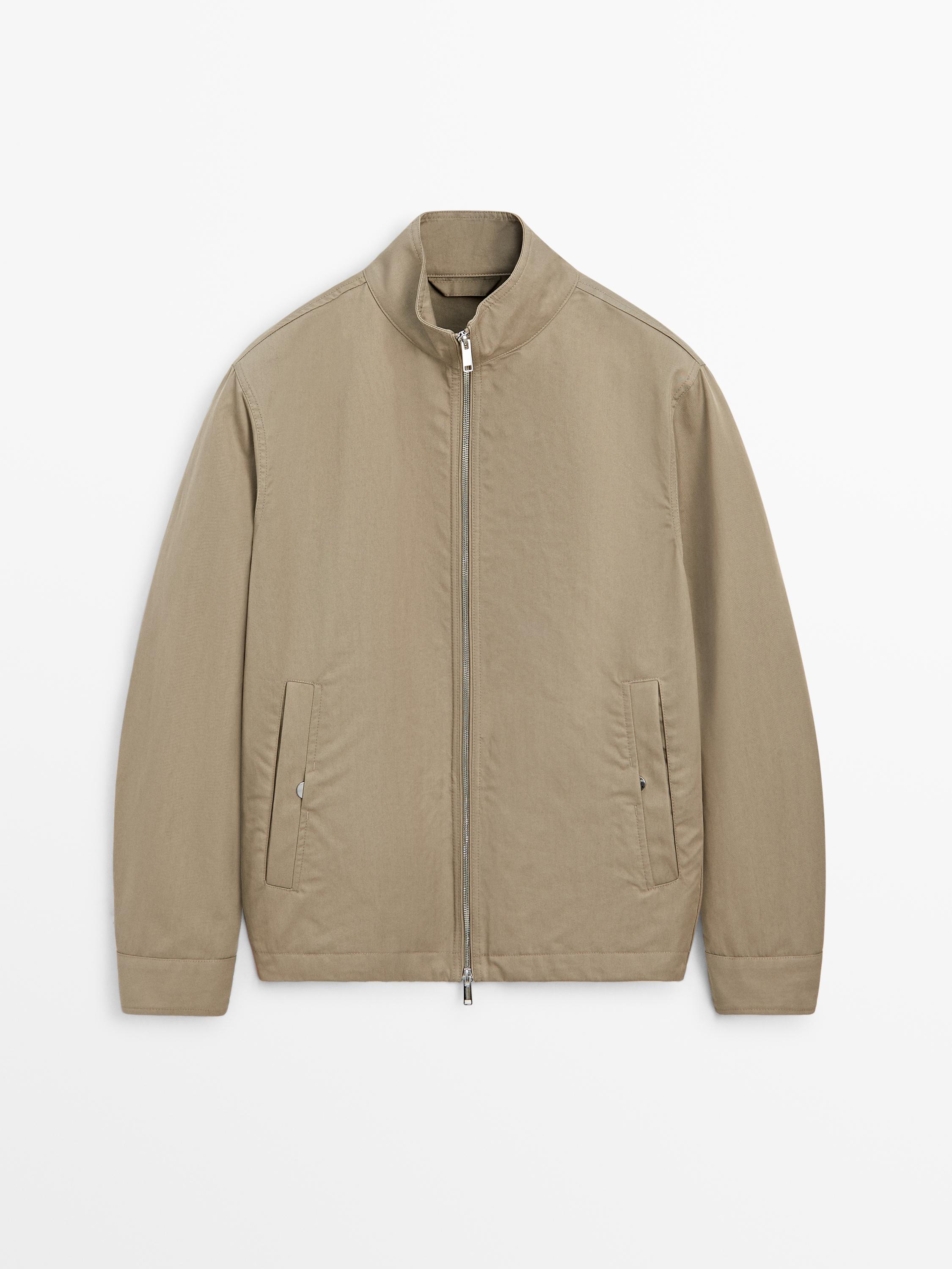 Front view of a toasted short jacket with a central zipper and side pockets.