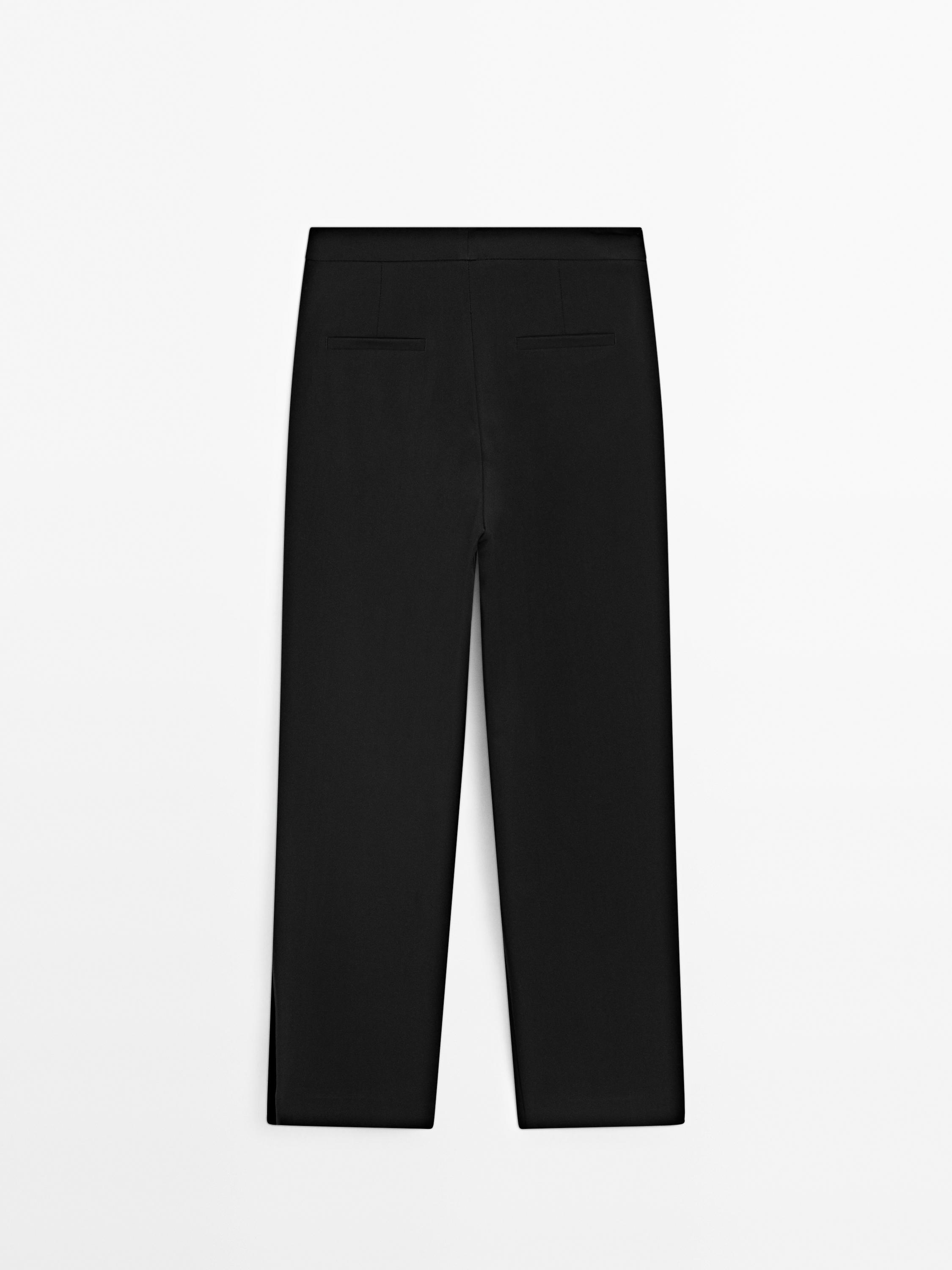 Trousers with buttoned hems