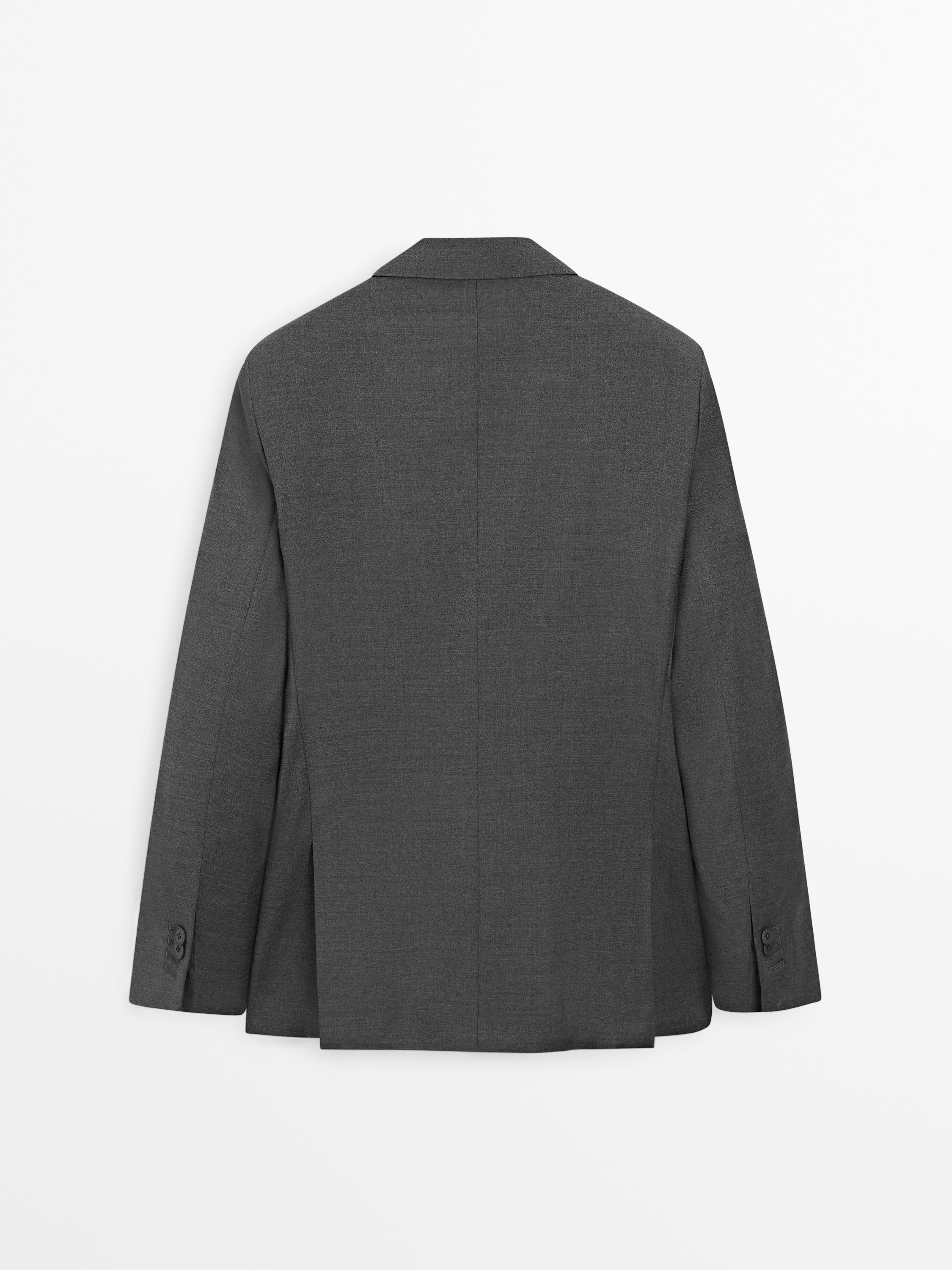 Rear view of a gray blazer with classic lapels and buttons on the sleeves.