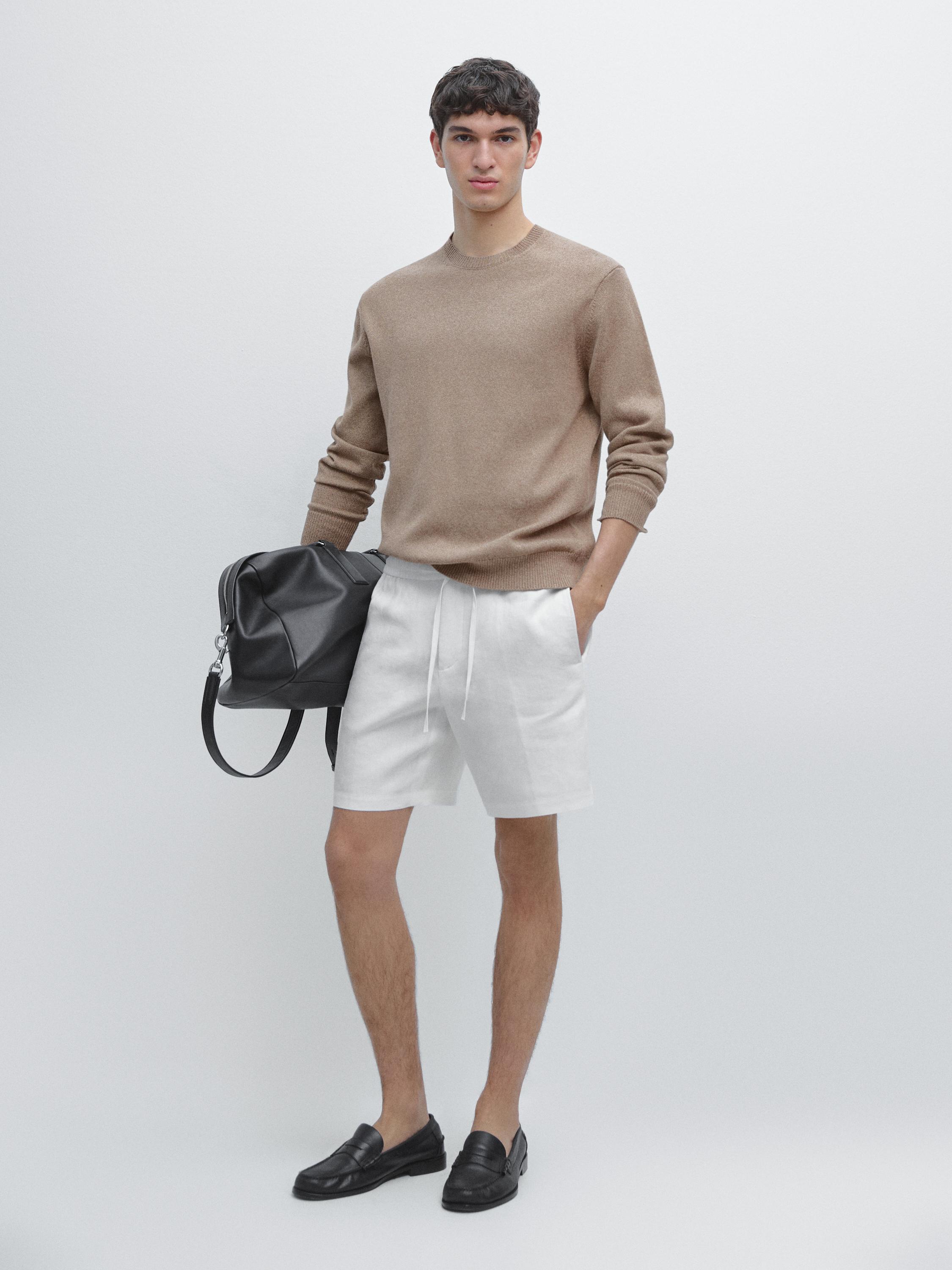 Beige sweater and white Bermuda shorts set with side pockets, adjustable drawstring, and black loafers.