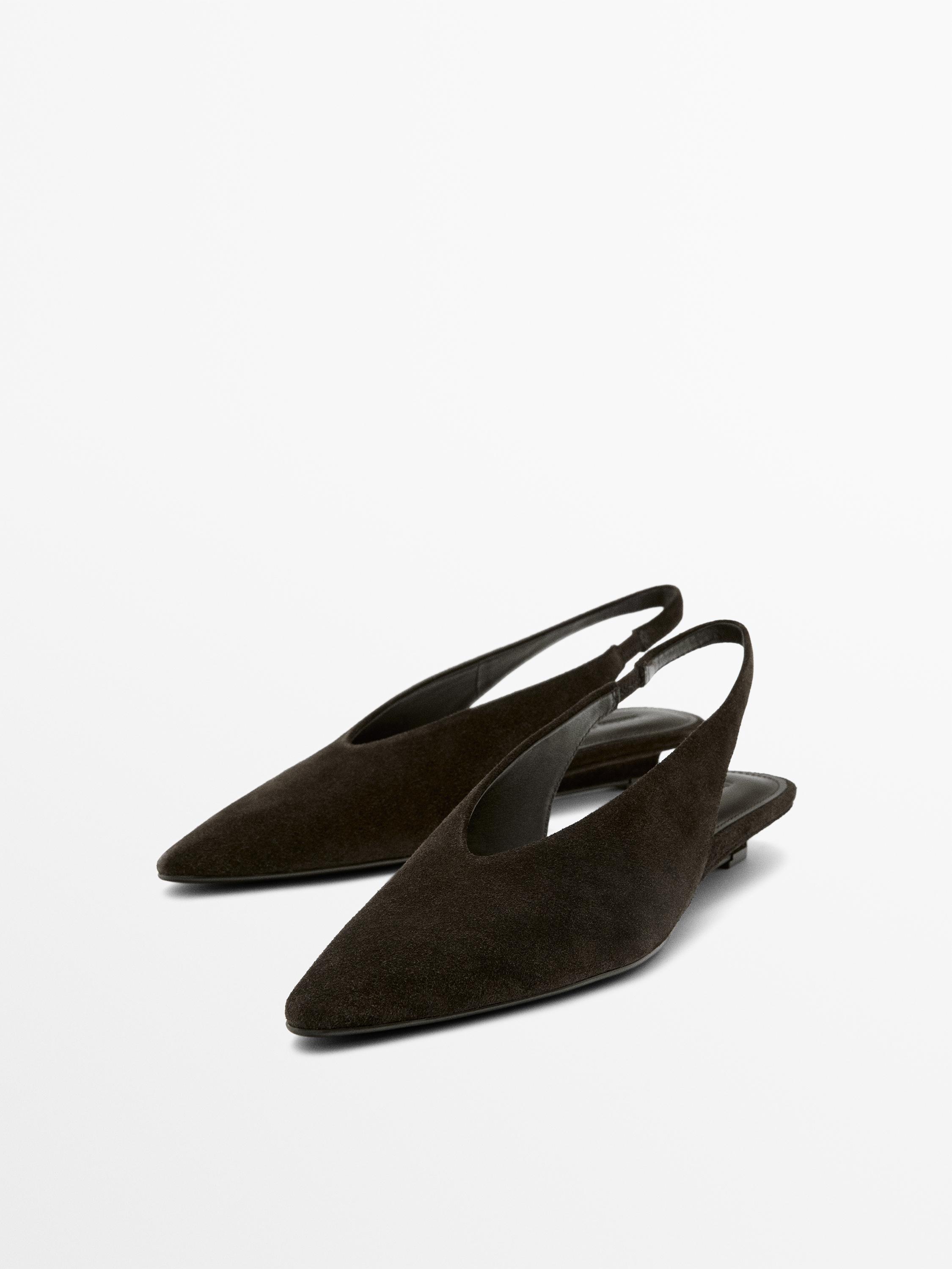 Brown pointed-toe slingback shoes, ballet flats style, with open heel and minimalist design.