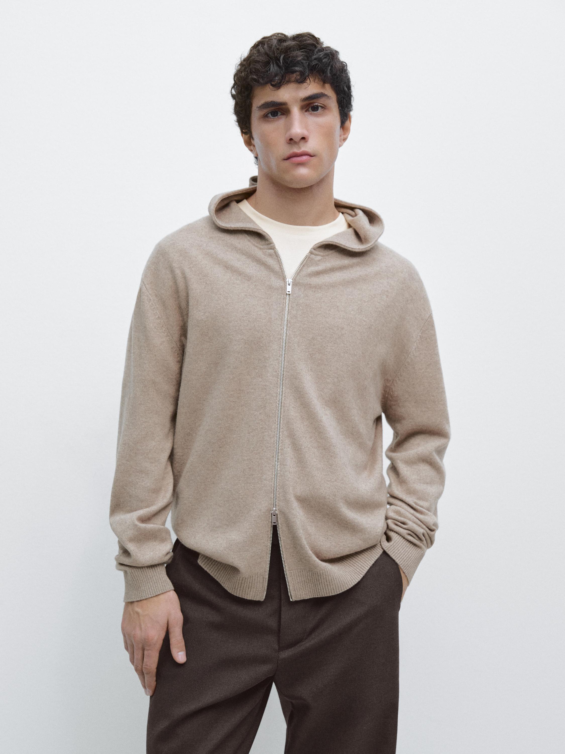 Mink hooded zip-up cardigan set, over a white t-shirt and brown pants.