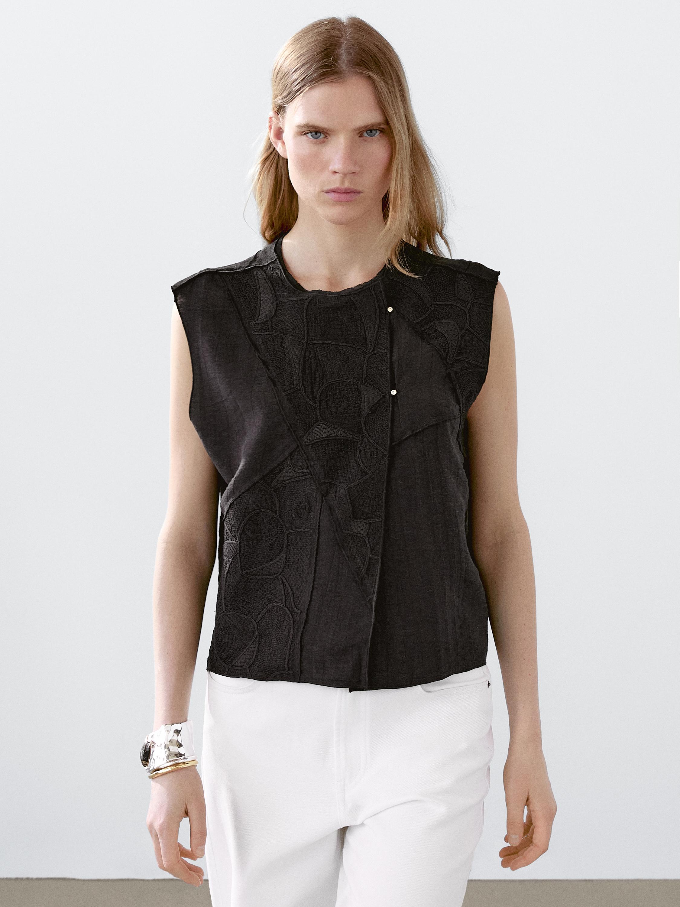 صديري مطرز بورجوندي، بدون أكمام، بإبزيم أمامي، مع بنطلون أبيض.