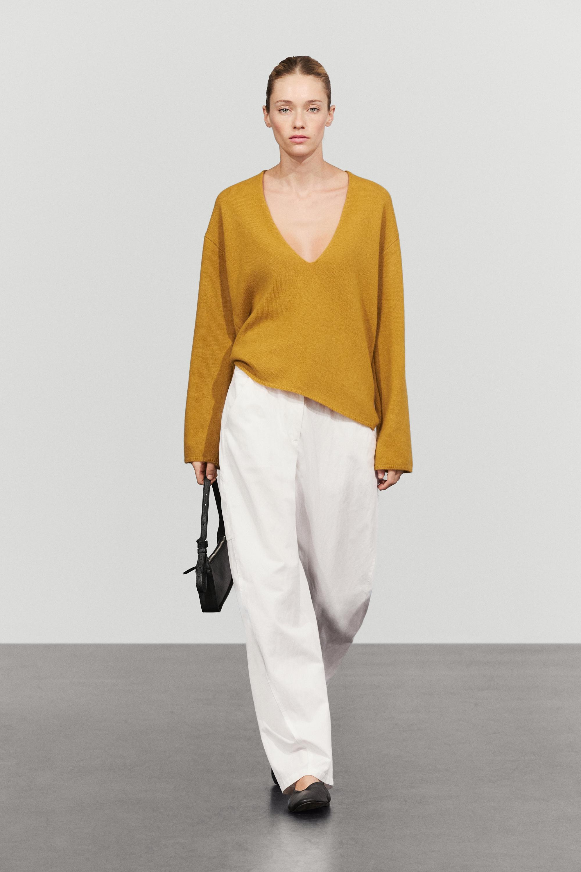 Long-line knit sweater with neckline detail