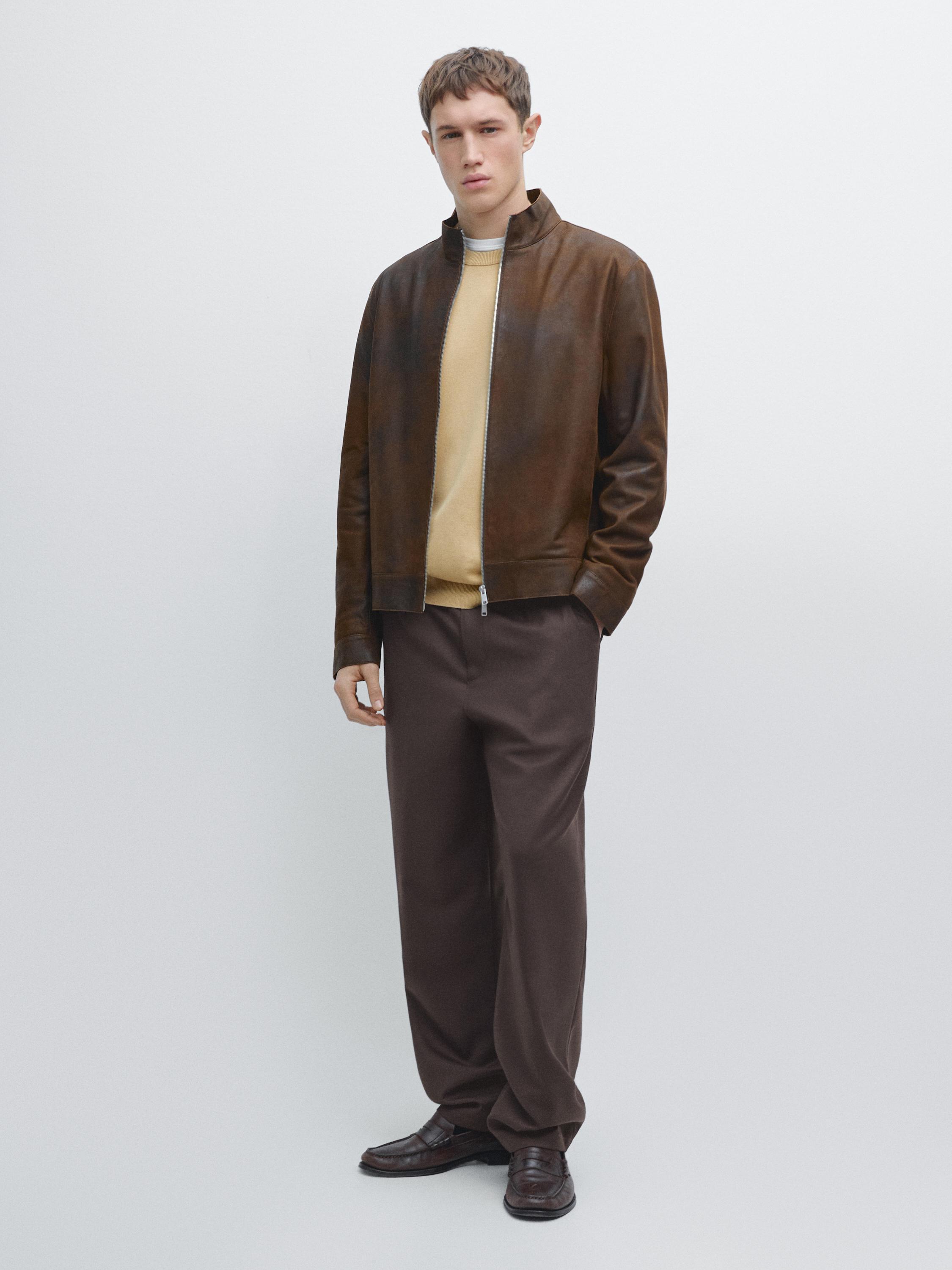 Brown zip-up jacket set, brown pants, and beige t-shirt.