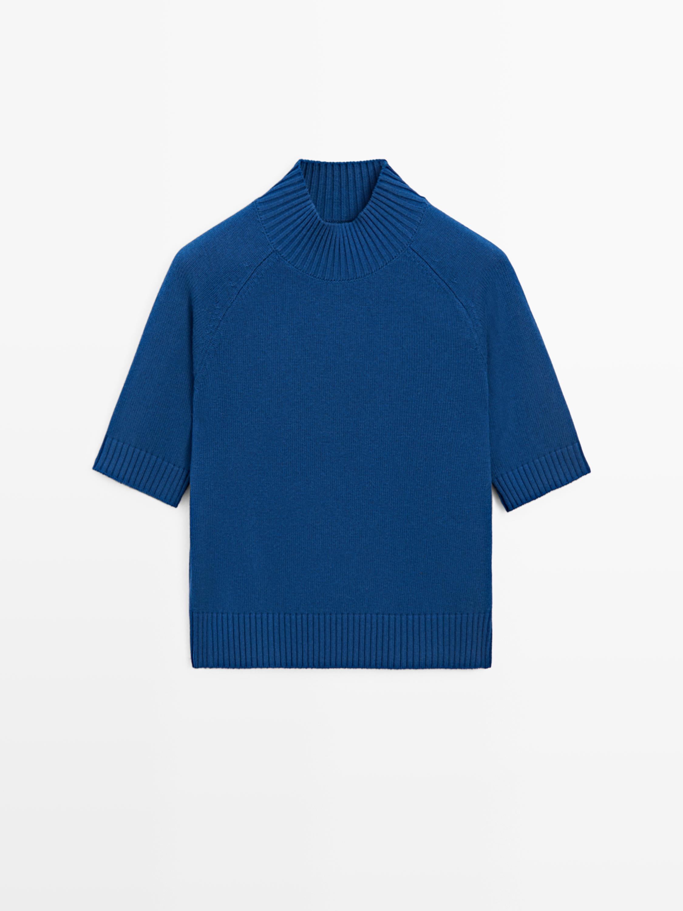 Front view of dark blue sweater with high neck and short sleeves. Ribbed detail on neck, cuffs and hem.