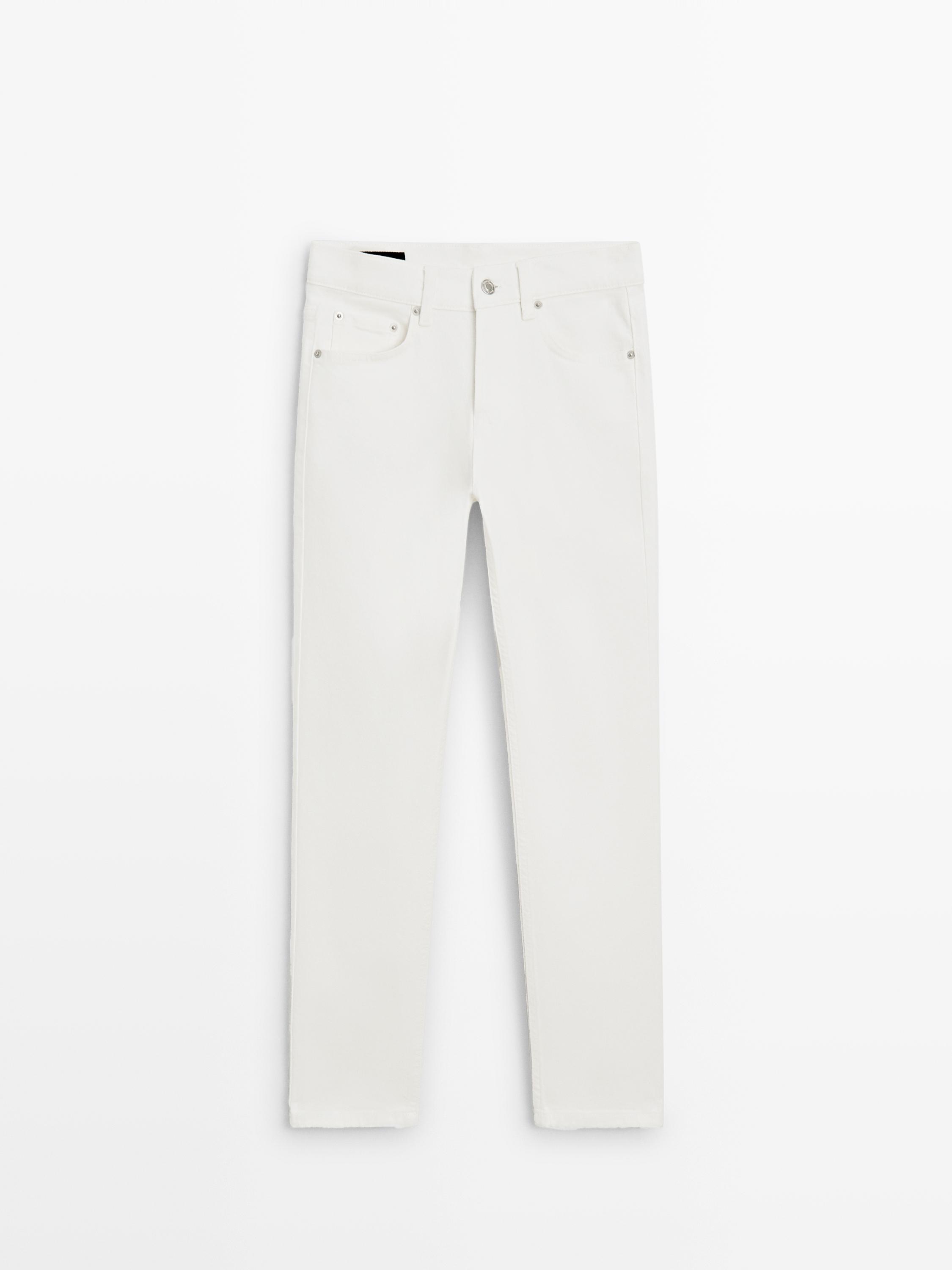 Front view of , mid-rise, slim-fit jeans with front and back pockets, button and zip closure.