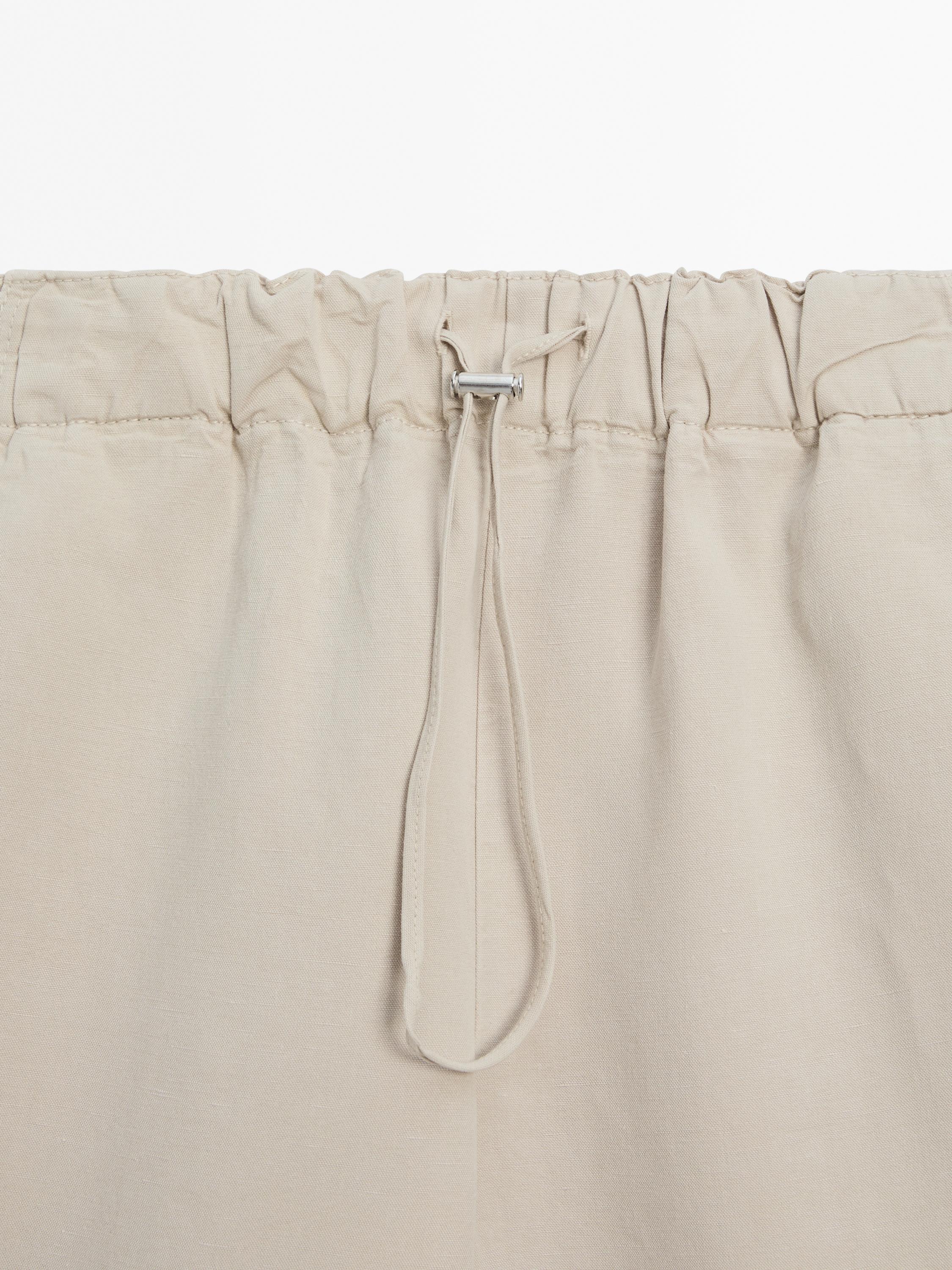 Trousers with elasticated waistband and adjustable hems