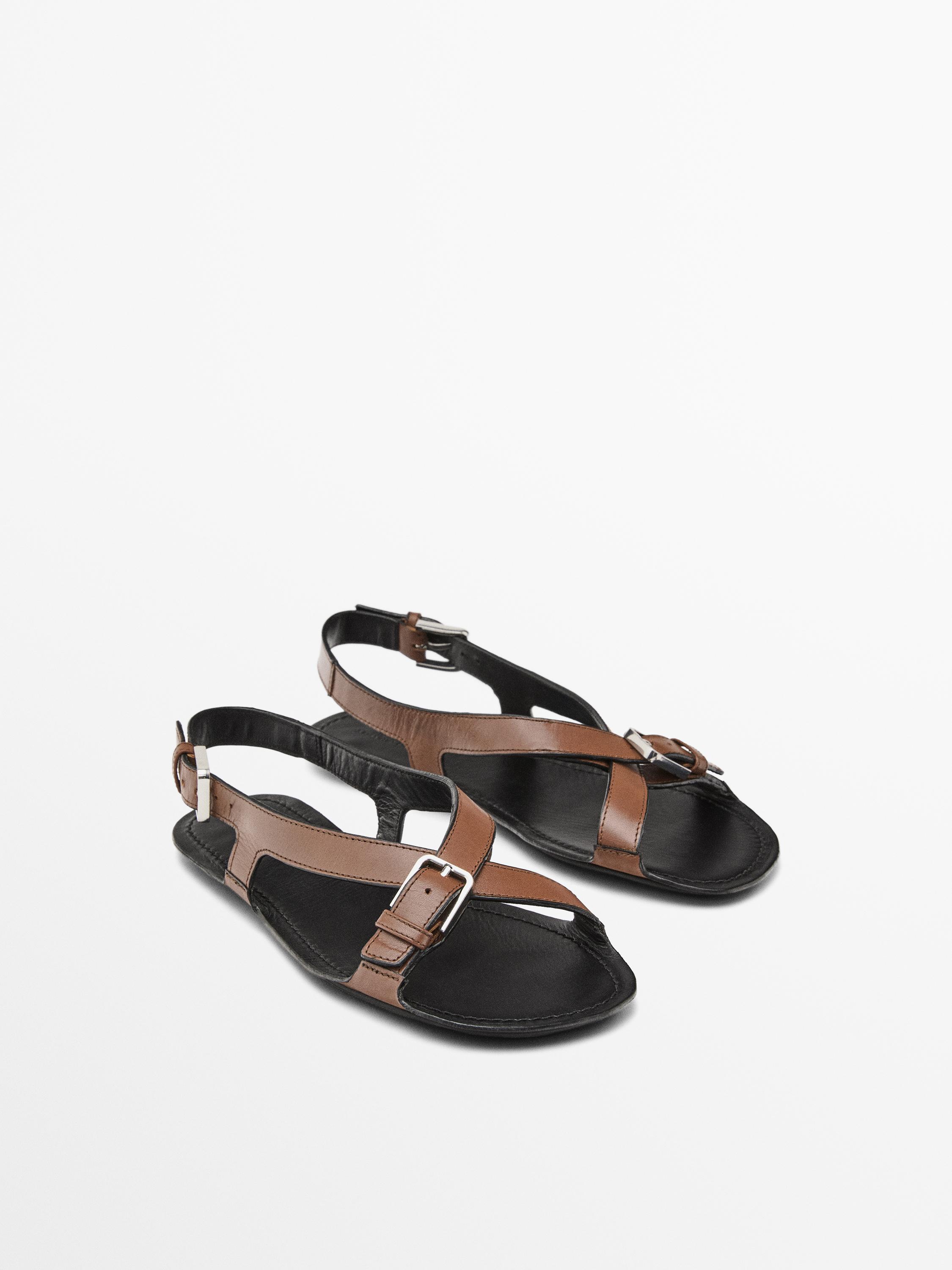 Flat leather sandals with buckles