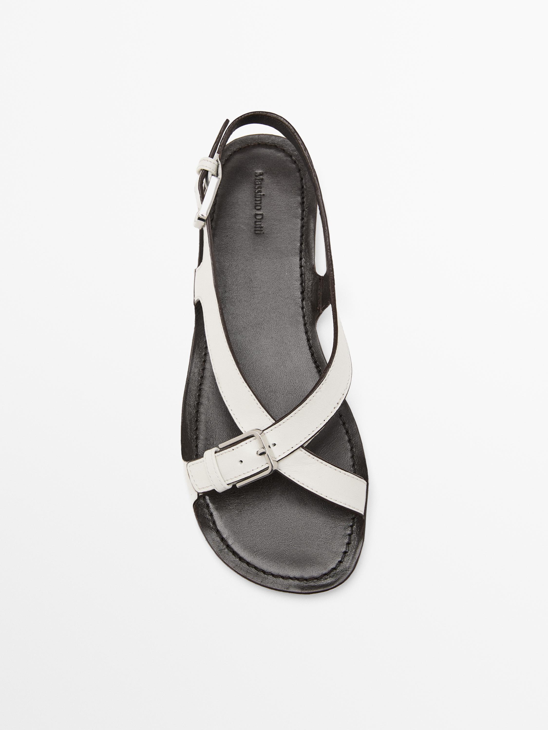 Flat leather sandals with buckles