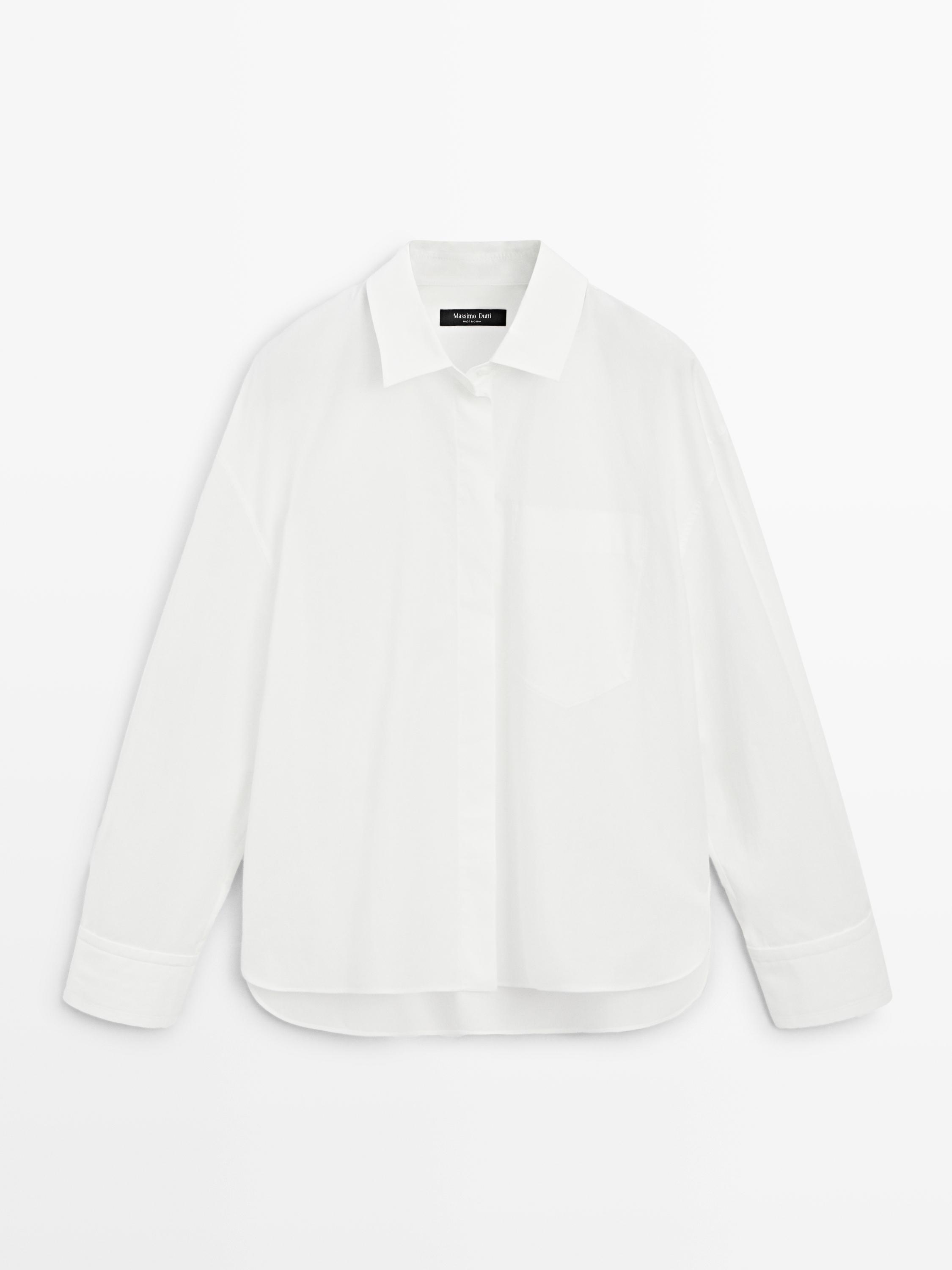 Front view of a white shirt with a classic collar, hidden placket, and chest pocket. Long sleeves with cuffs.