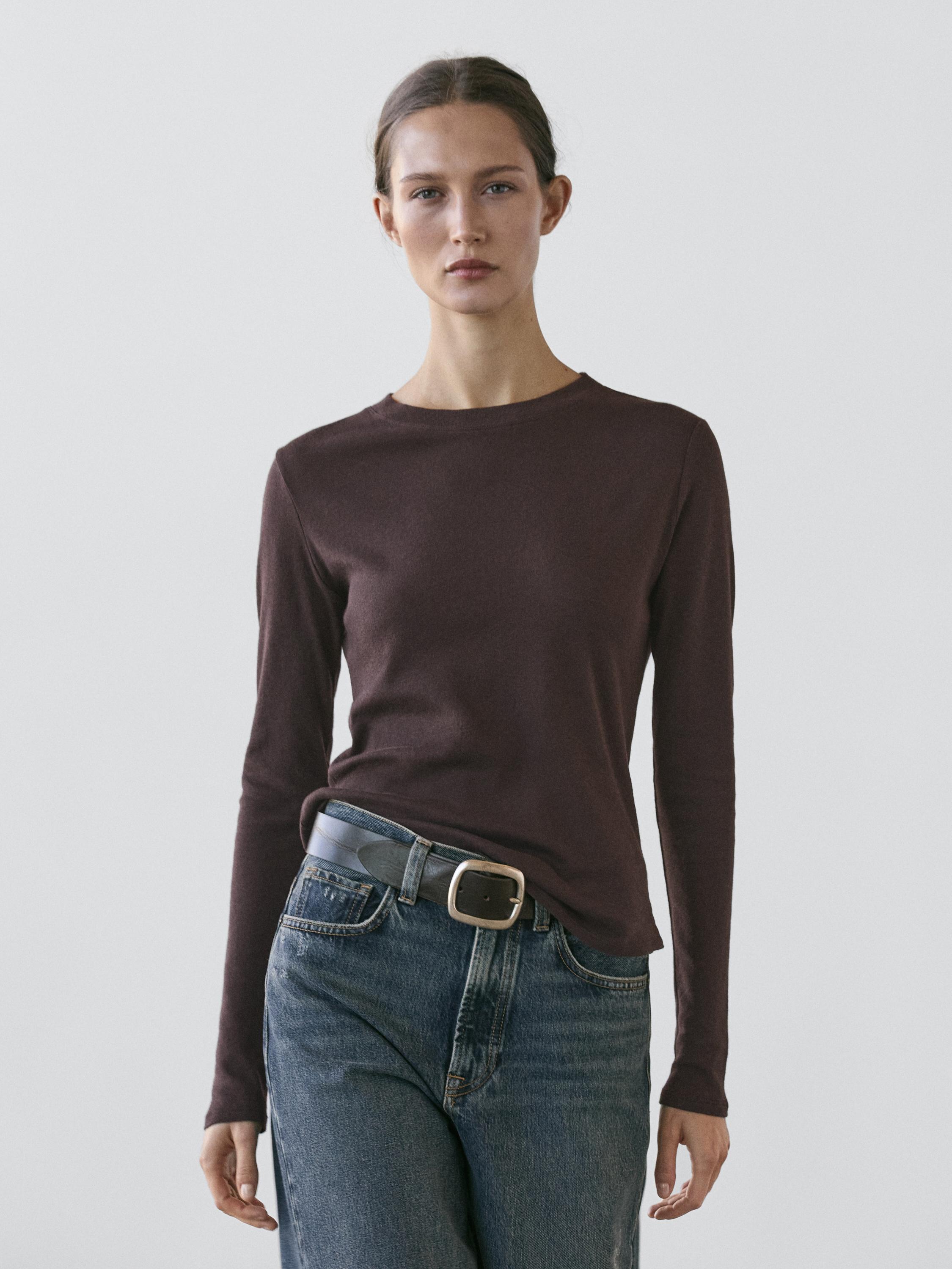 Brown long-sleeve T-shirt and blue jeans set with a black belt.