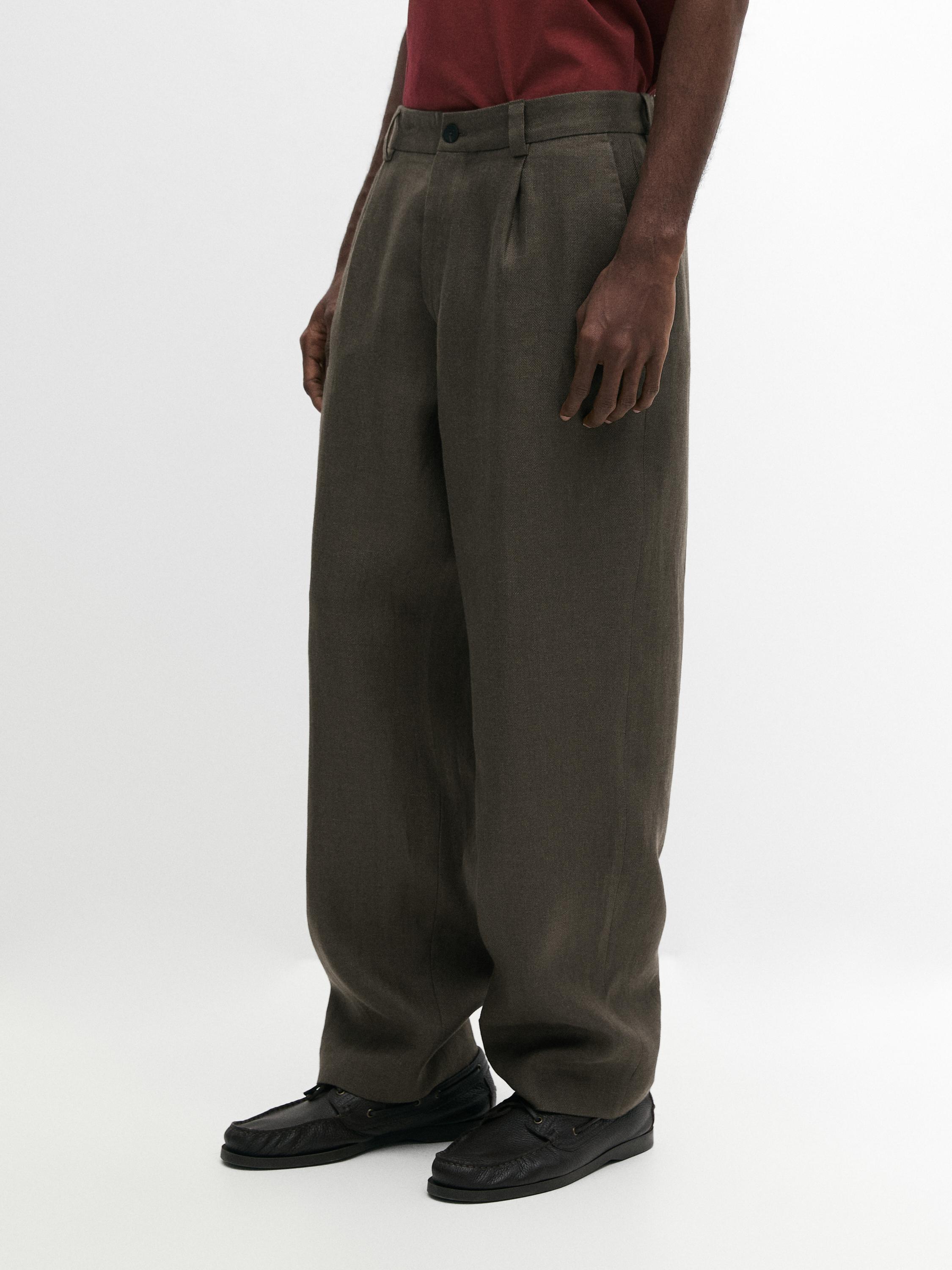 Conjunto de pantalón verde de corte ancho con pinzas y bolsillos laterales.