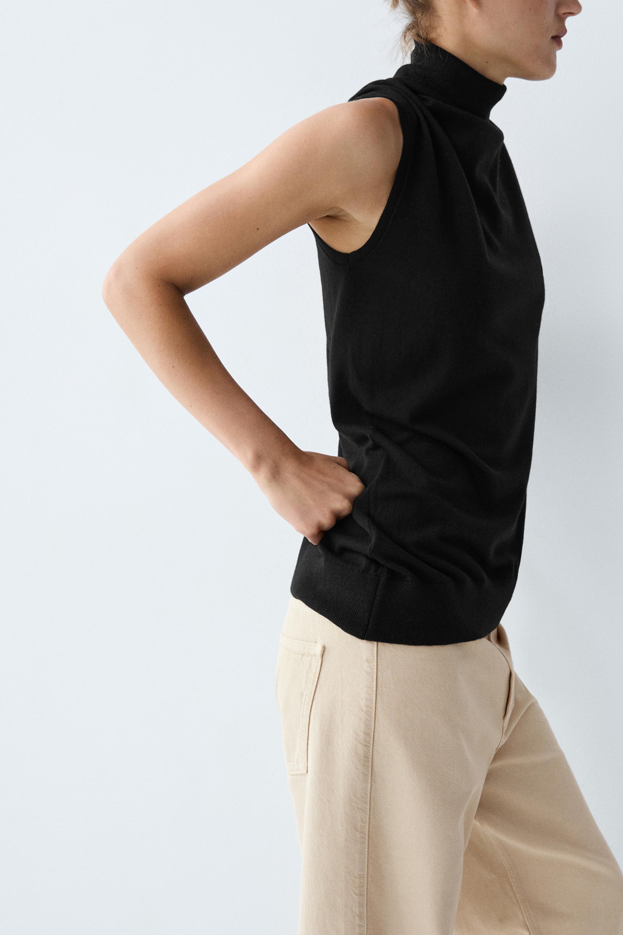 Asymmetric hem turtleneck top — BLACK