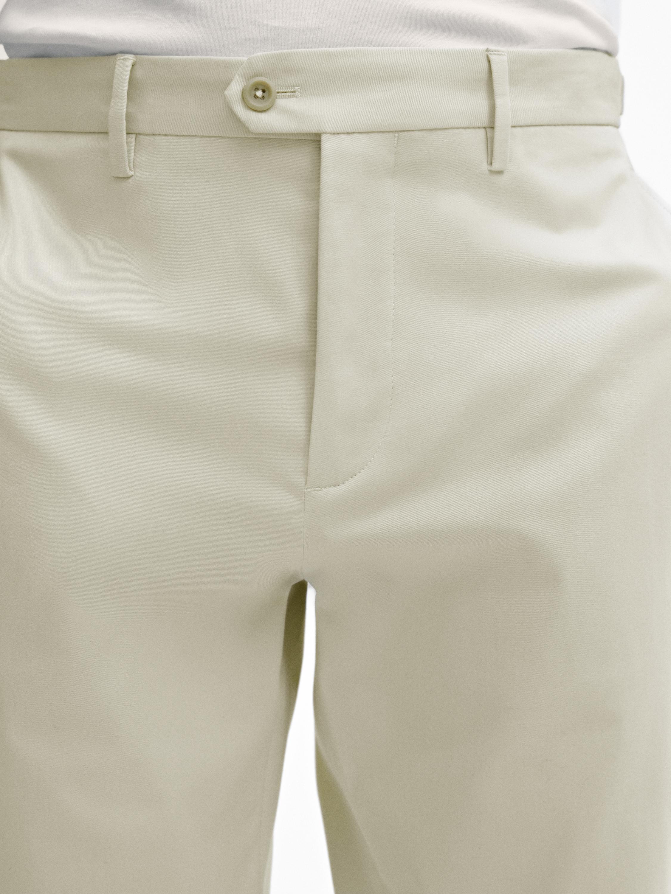 Tapered fit trousers with buckle detail