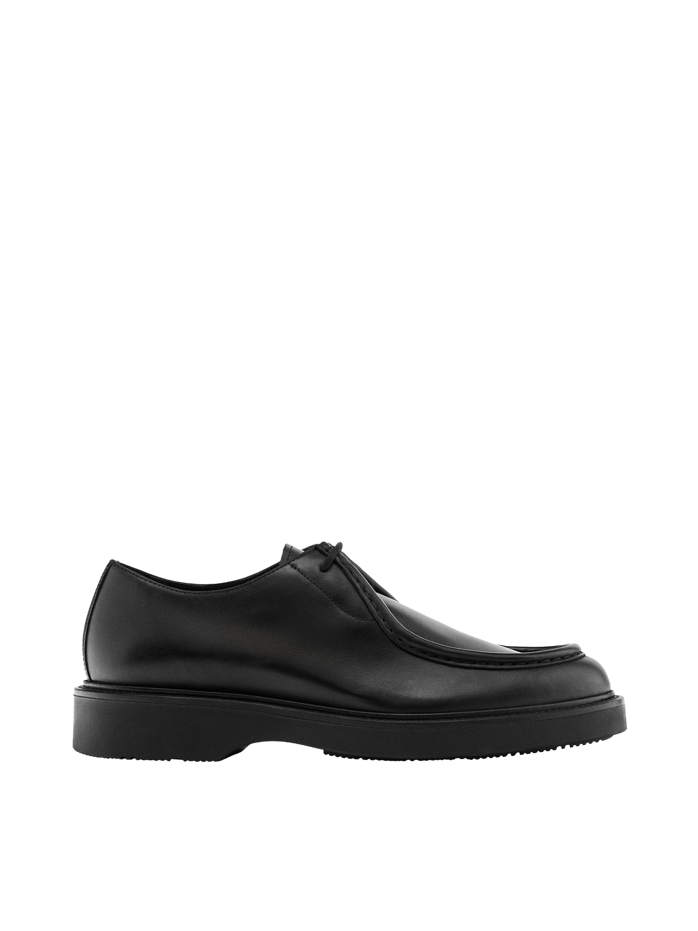 "Side view of a black lace-up shoe with a thick sole."