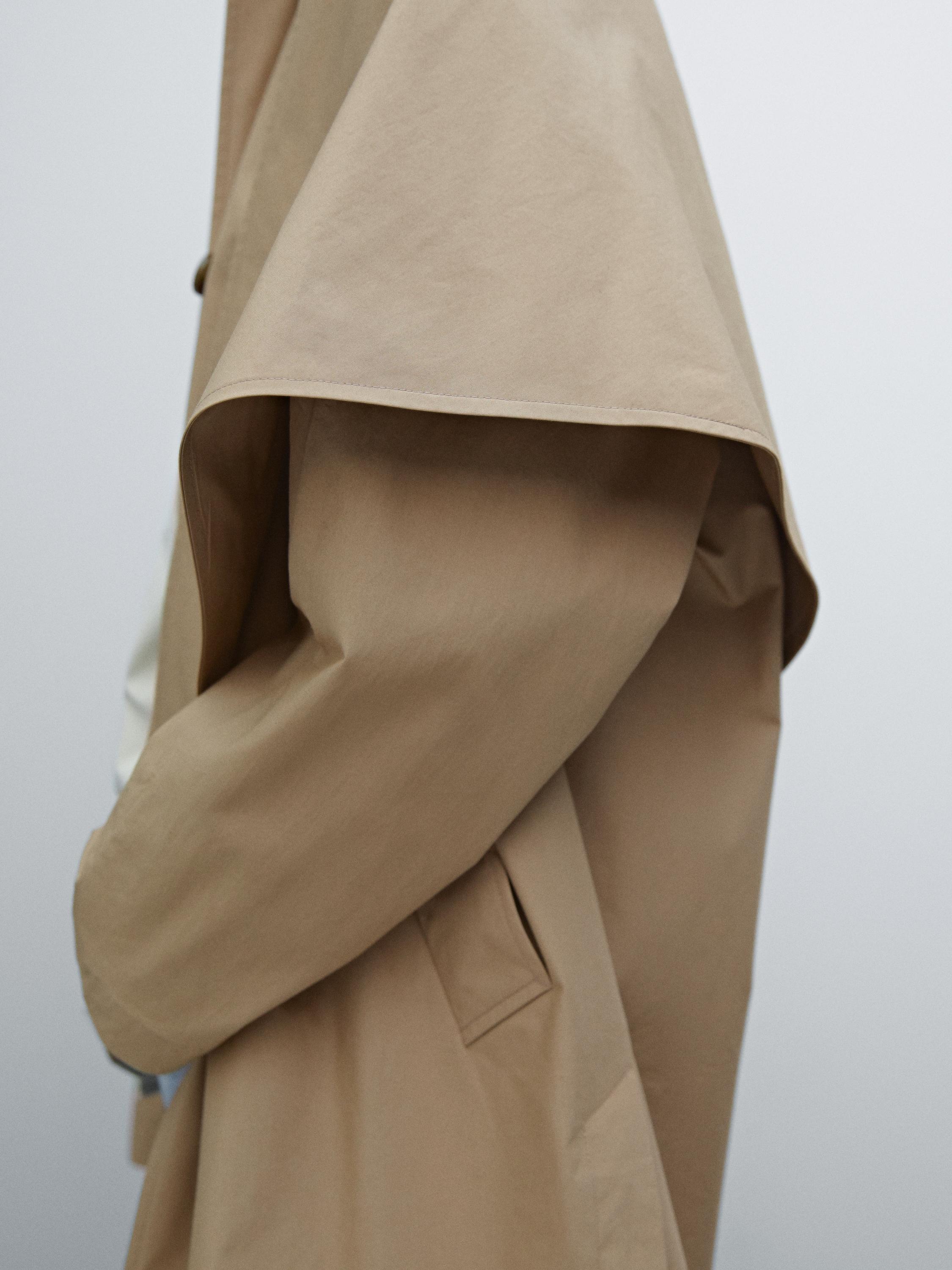 Trench coat with detachable scarf detail