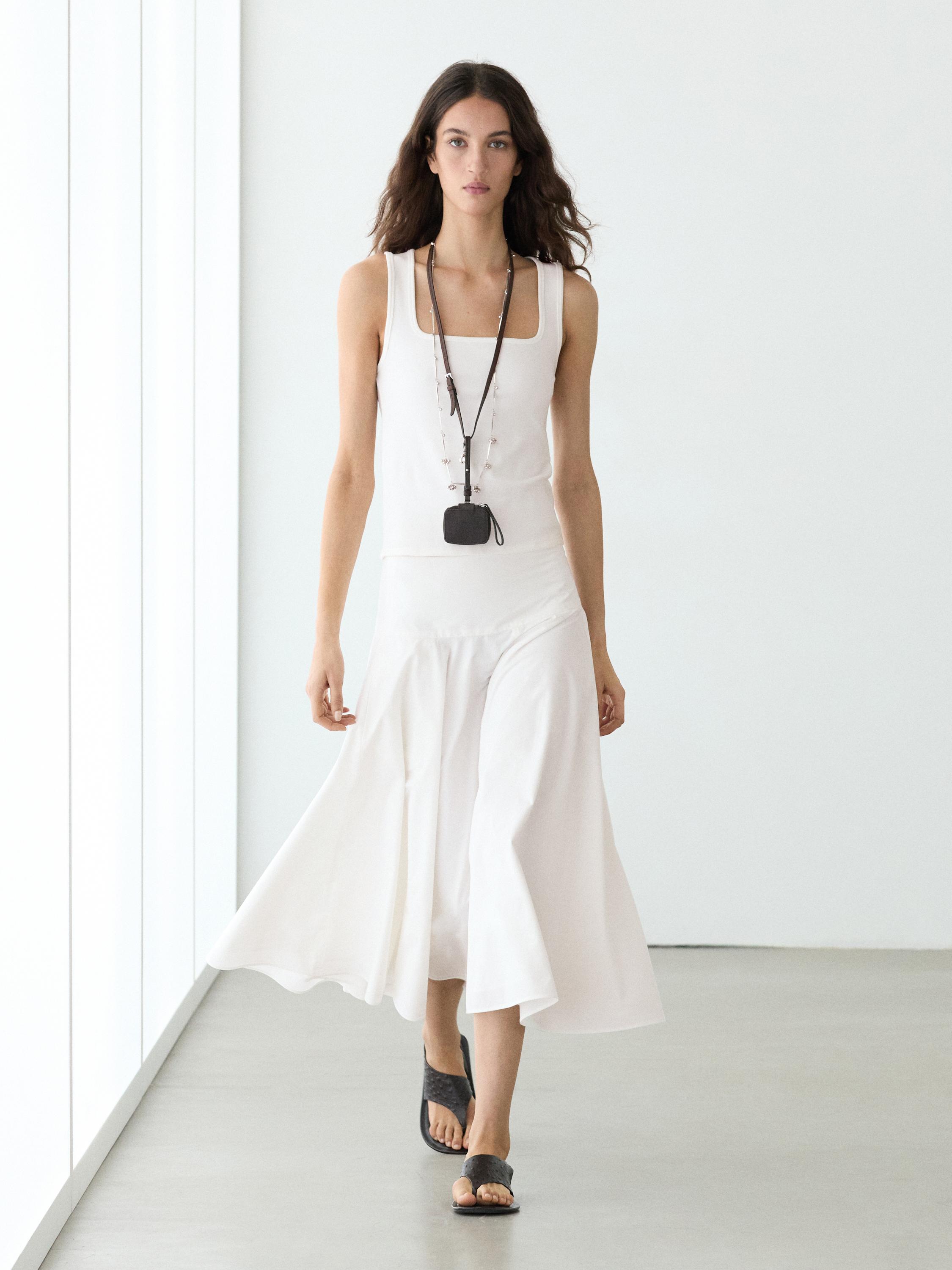 White midi skirt and white sleeveless top set with yoke.