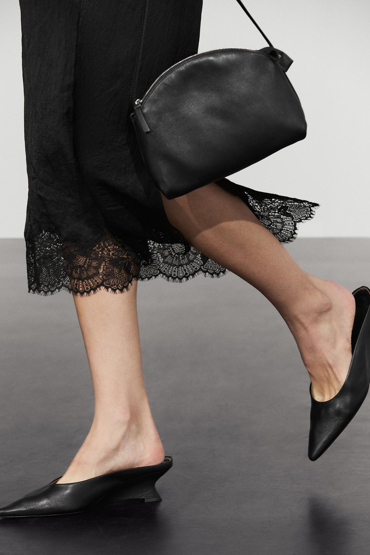 Flowing midi skirt with lace detail — BLACK