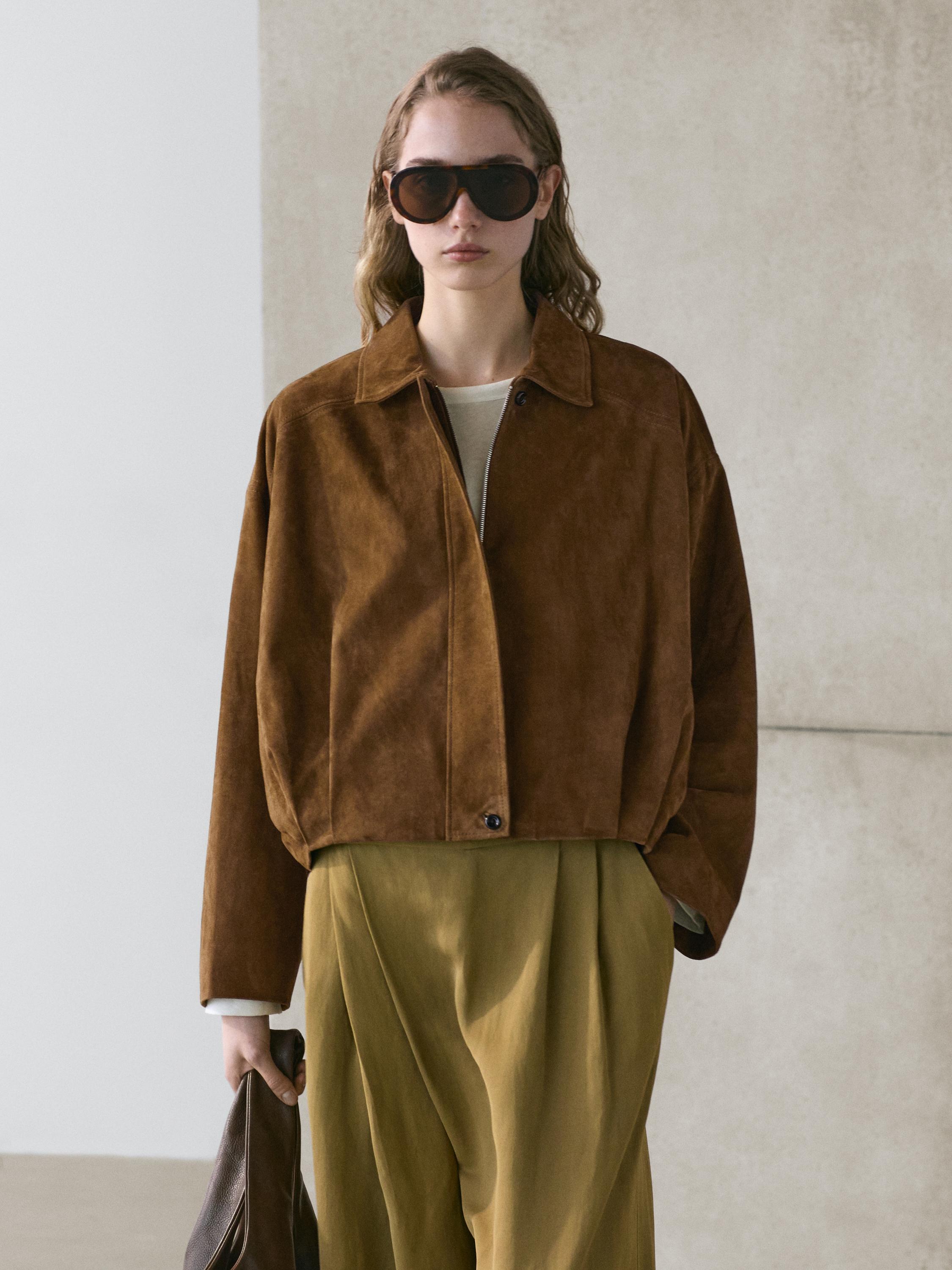 Brown cropped jacket set with front closure and olive green loose-fit pants.