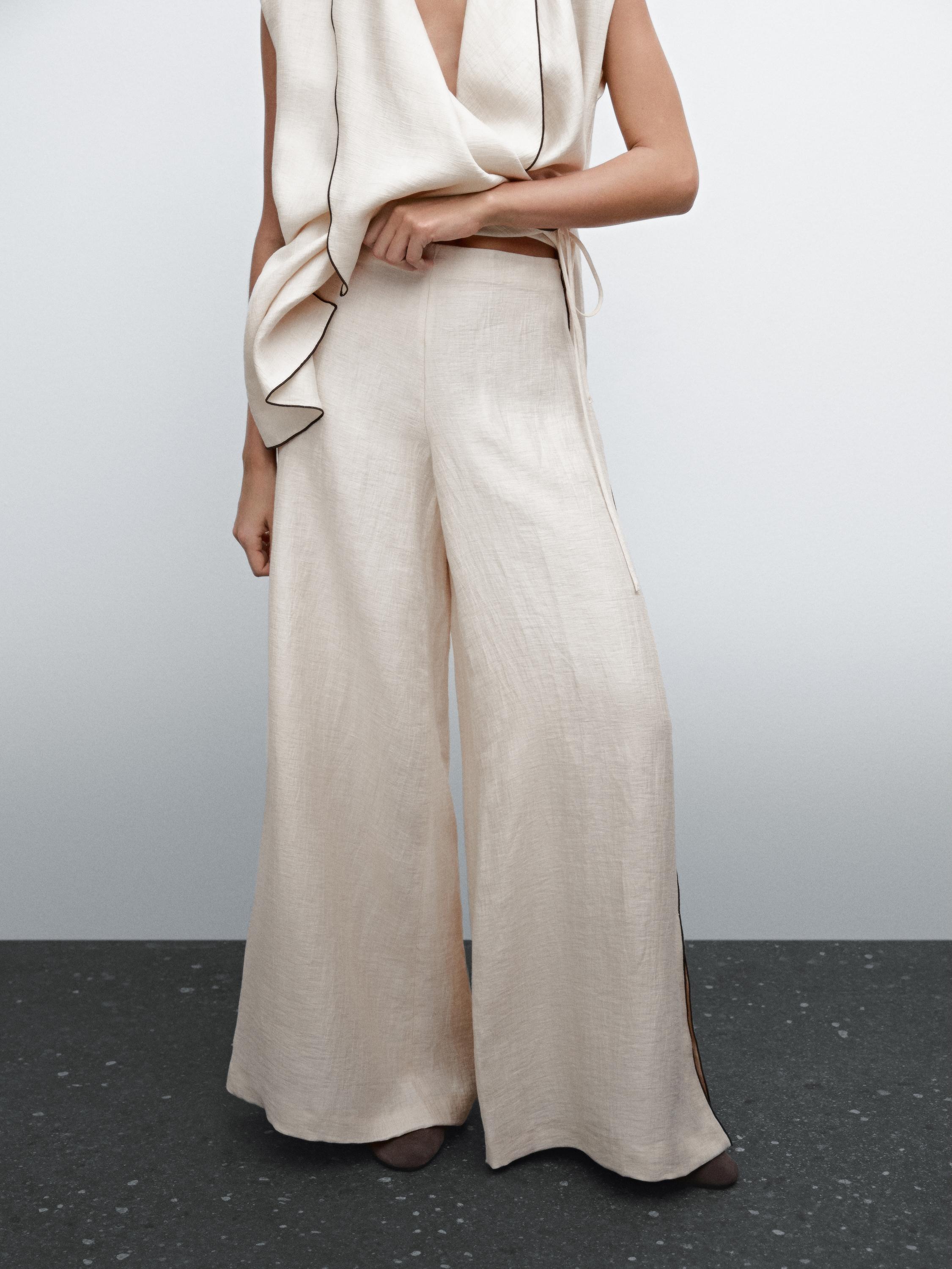 Flowing trousers with contrast trims