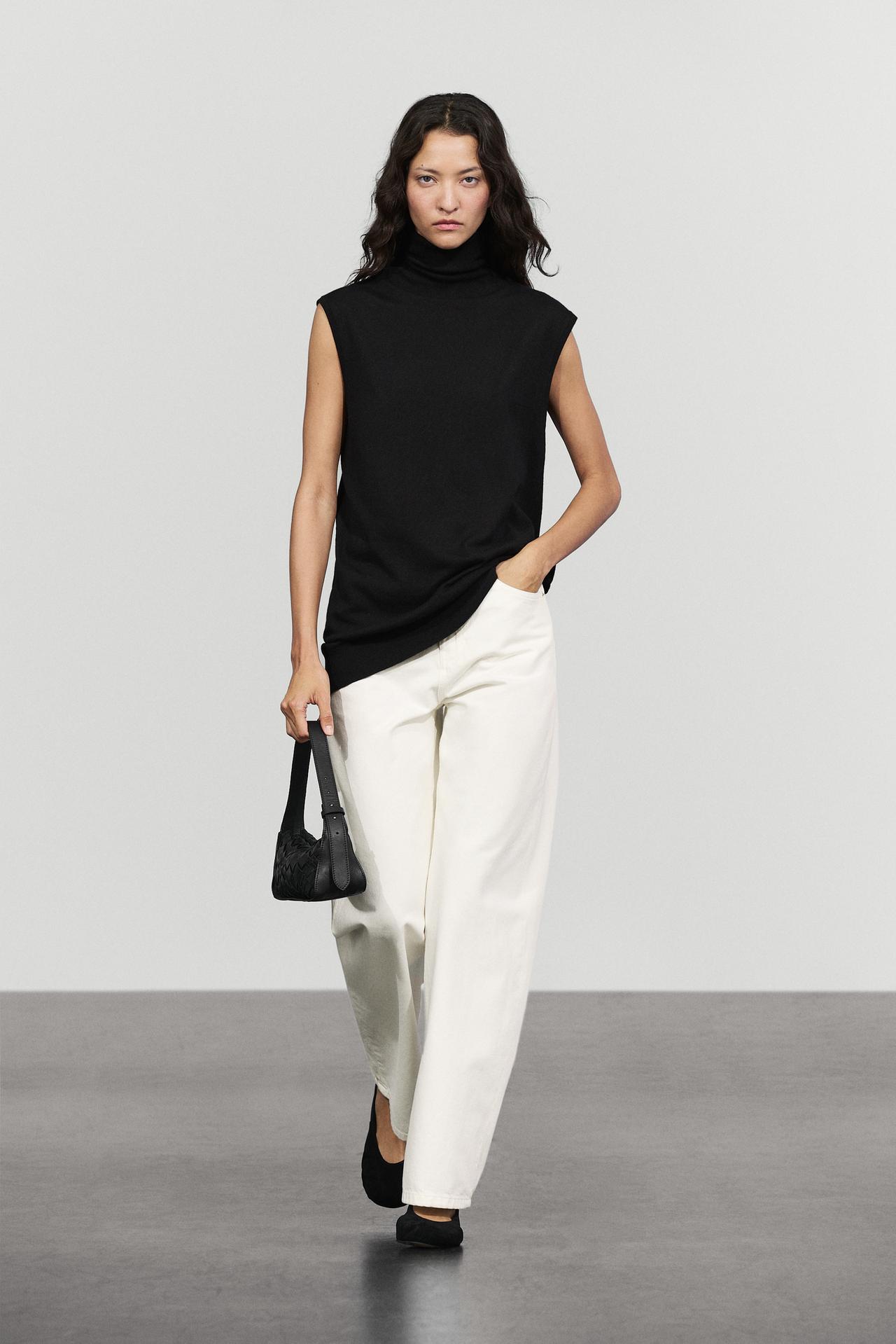 Asymmetric hem turtleneck top — BLACK