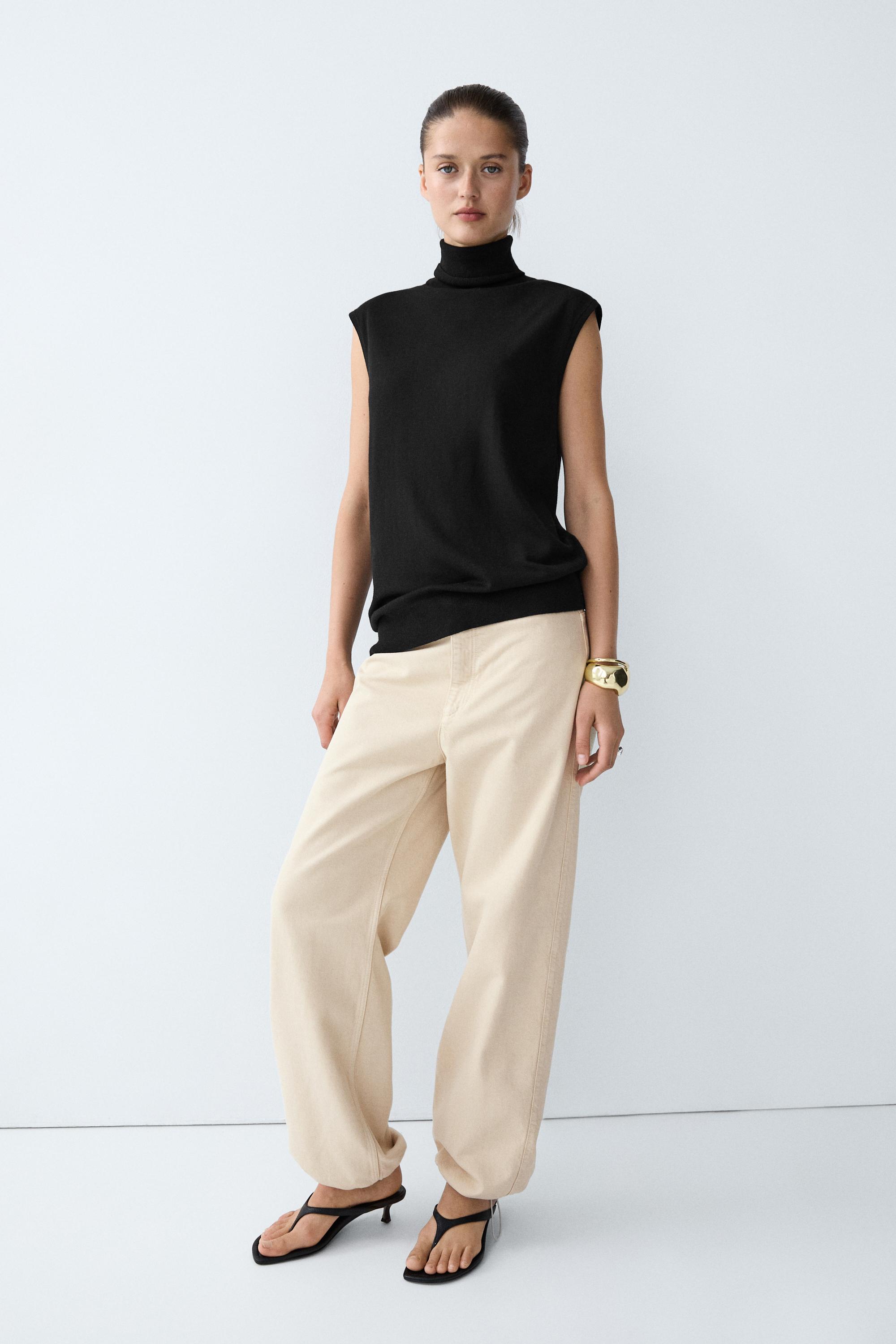 Asymmetric hem turtleneck top — BLACK