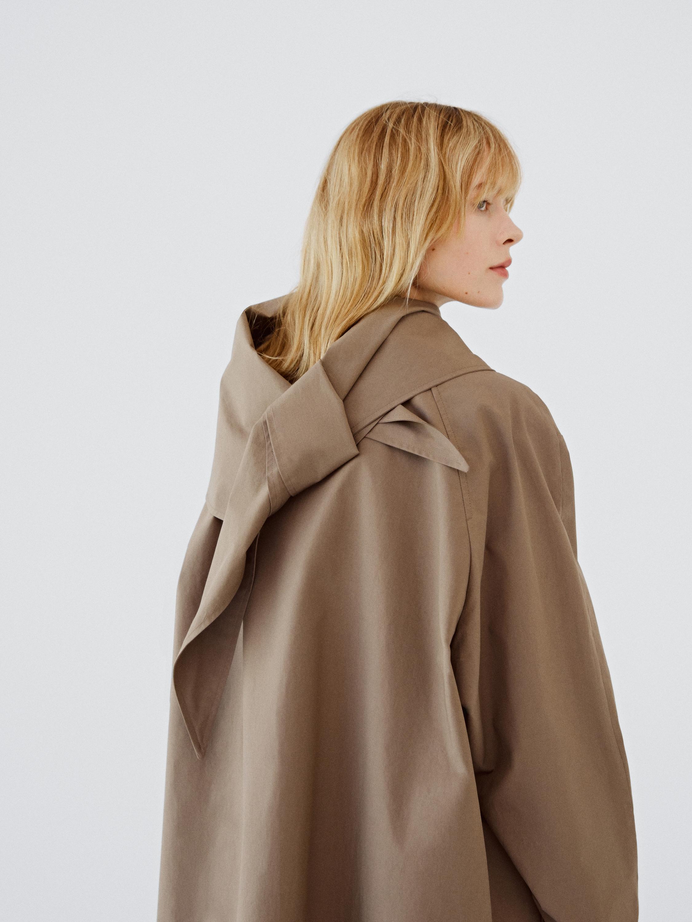 Trench coat with detachable scarf detail