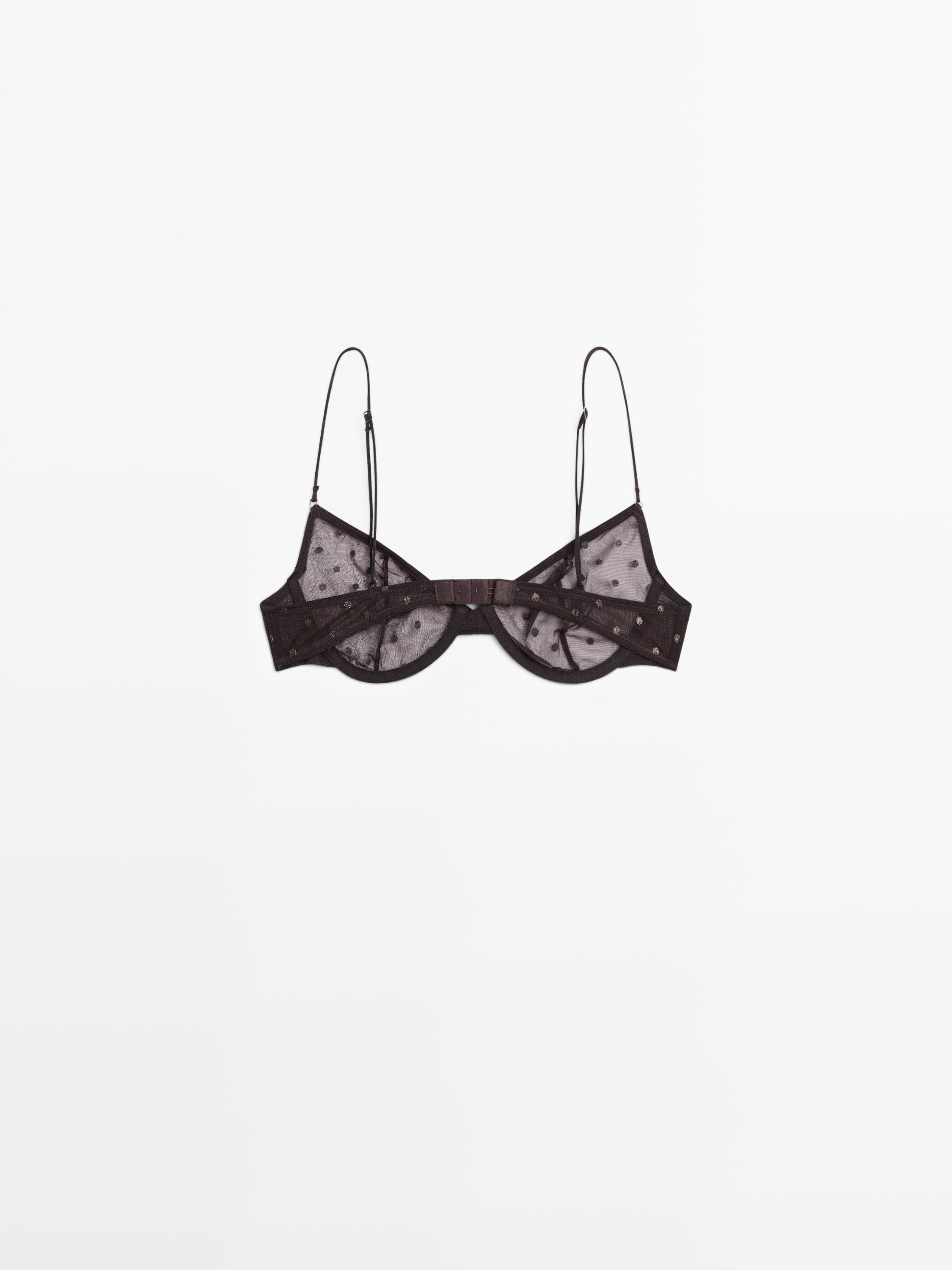 Vista frontal de sostenidor marró talp amb tirants fins i disseny de lunars.