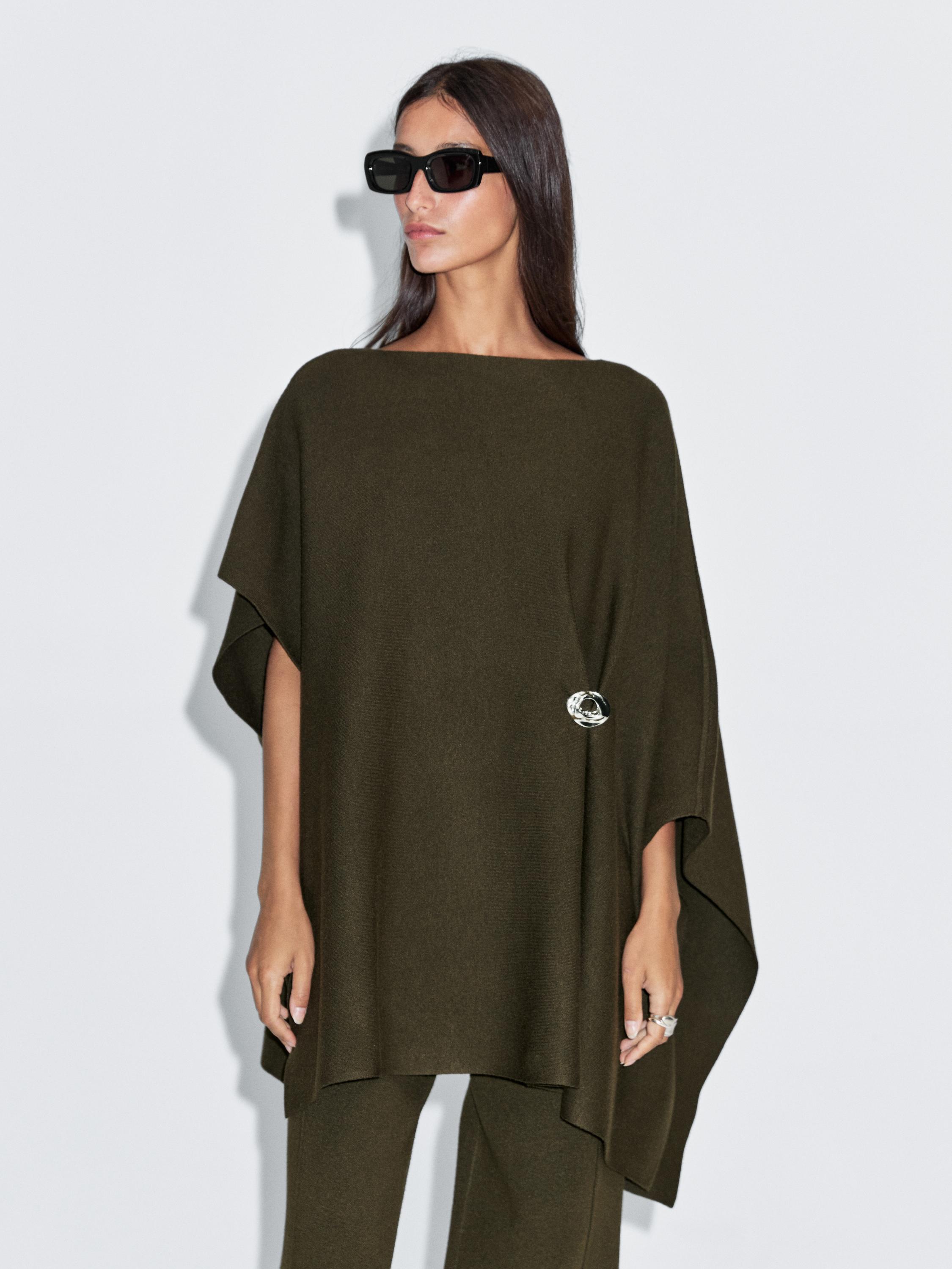 Knit cape with brooch detail