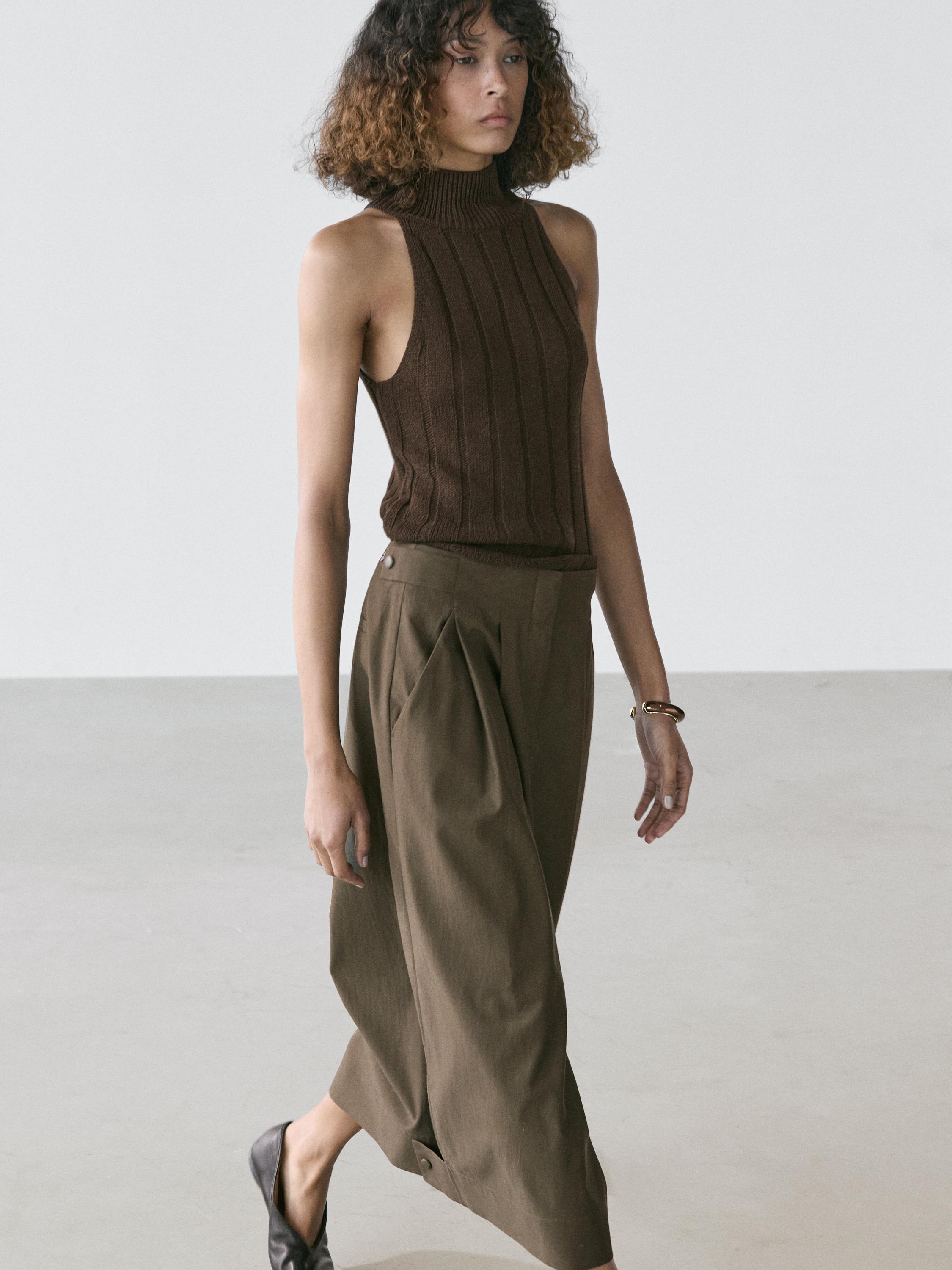 Sleeveless brown top and khaki midi skirt set with pleats and side buttons.