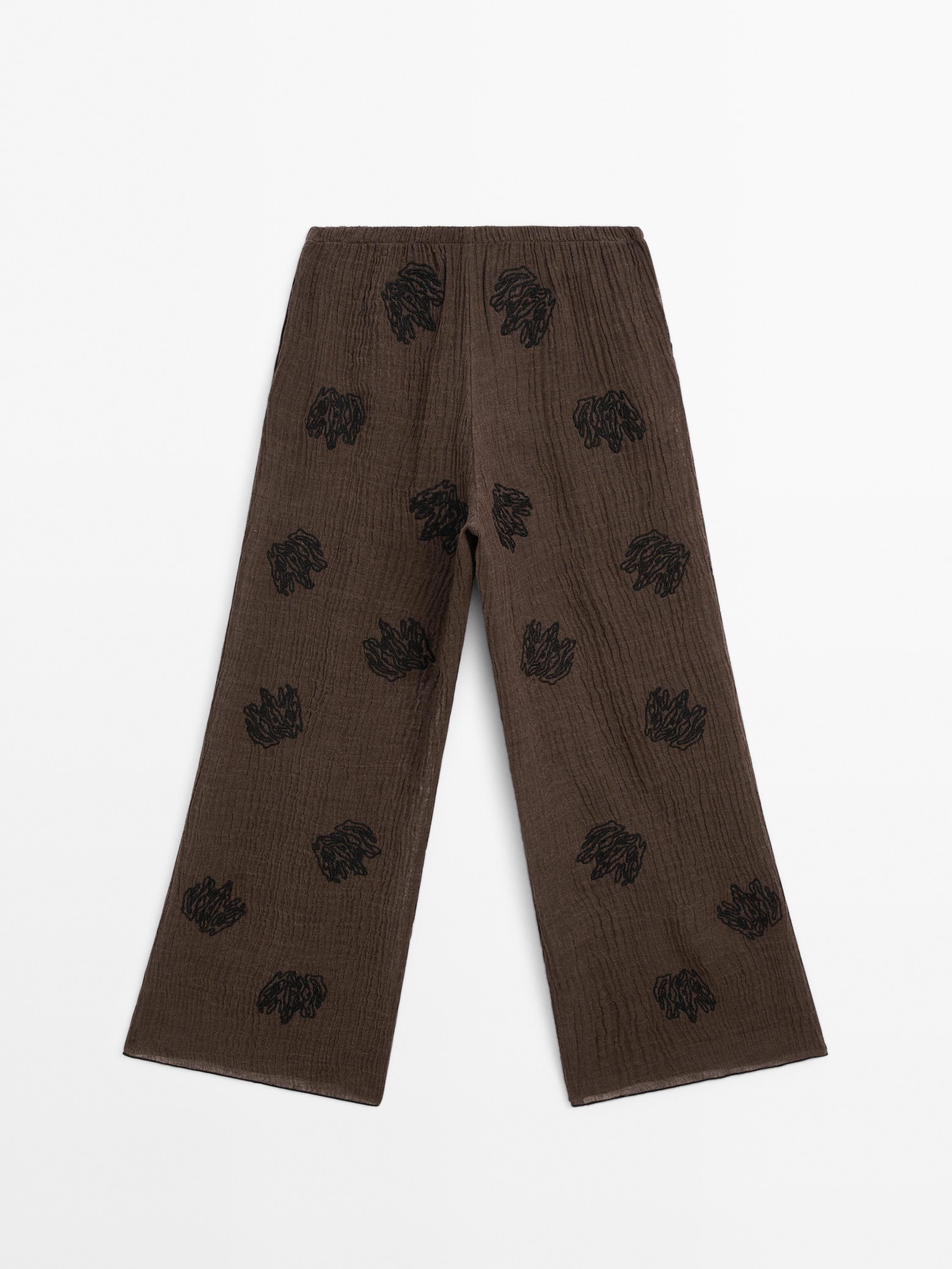 Flowing textured trousers with embroidered detail