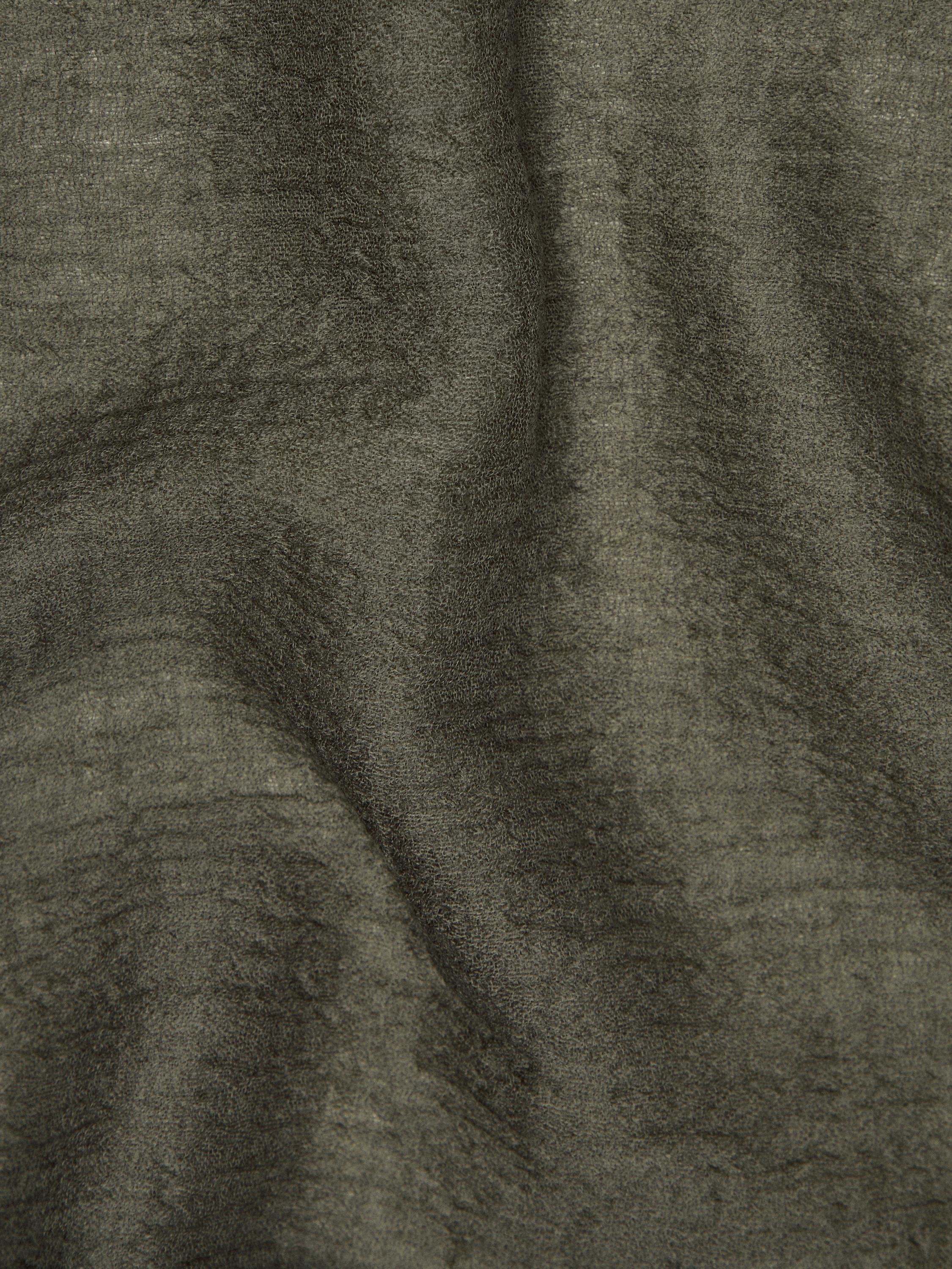 Flowing wool scarf with frayed edges